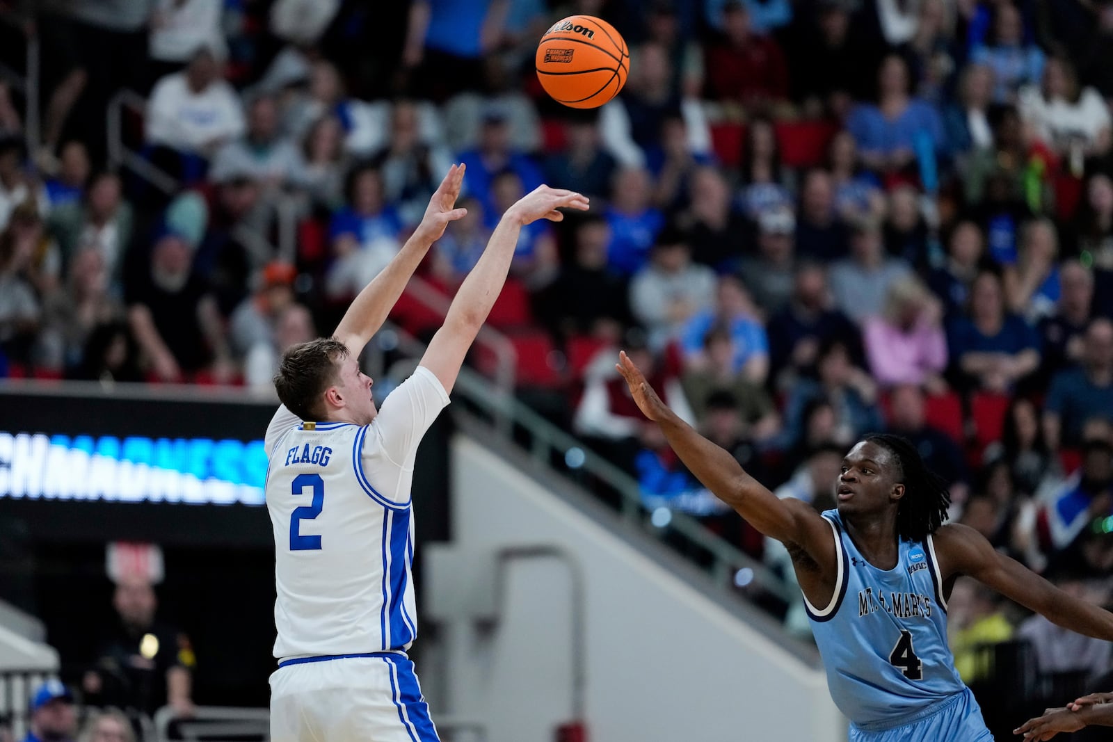 Duke forward Cooper Flagg (2) shoots against Mount St. Mary's forward Dola Adebayo (4) during the first half in the first round of the NCAA college basketball tournament, Friday, March 21, 2025, in Raleigh, N.C. (AP Photo/Stephanie Scarbrough)