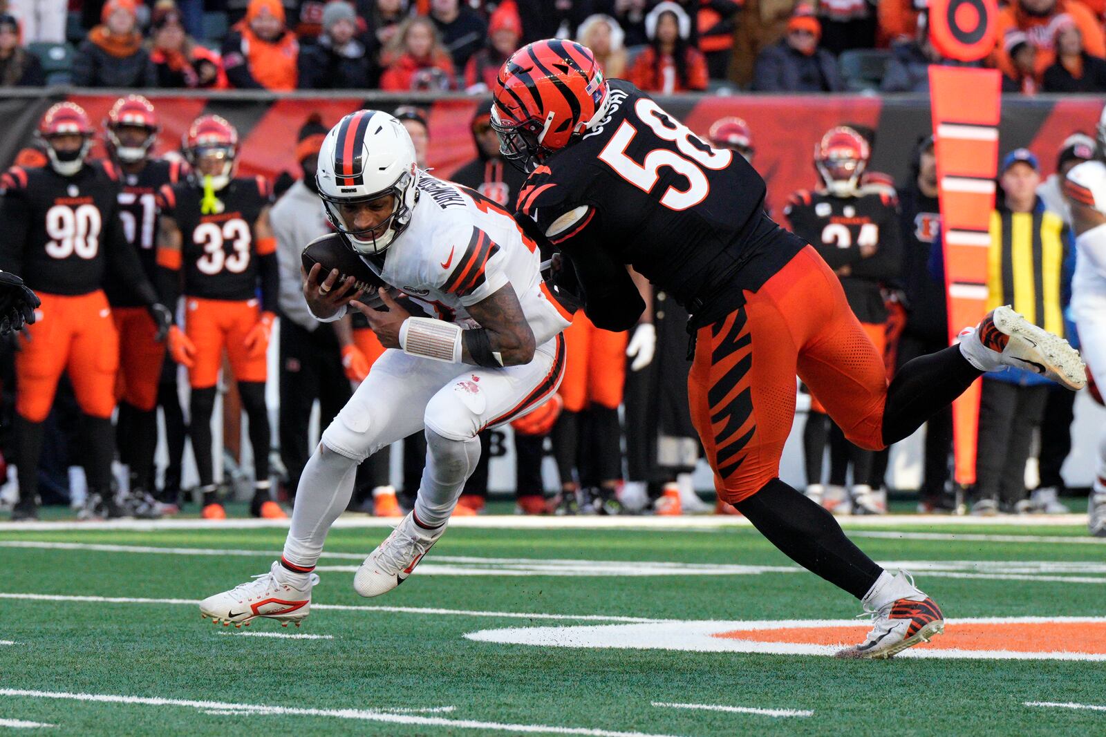 Cincinnati Bengals defensive end Joseph Ossai (58) sacks Cleveland Browns quarterback Dorian Thompson-Robinson during the second half of an NFL football game, Sunday, Dec. 22, 2024, in Cincinnati. The Bengals won 24-6. (AP Photo/Jeff Dean)