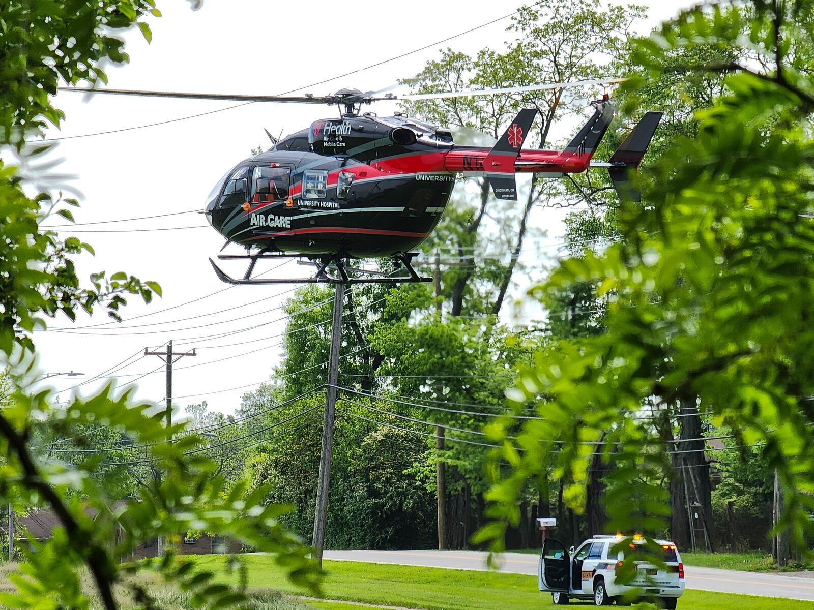 A UC Health Air Care medical helicopter landed around 11 a.m. Thursday, May 11, 2023, in front of the Butler County Sheriff's Office dispatch center on Princeton Road to transport a woman with burn injuries from a fire on Arroyo Ridge Court in Fairfield Twp. NICK GRAHAM/STAFF