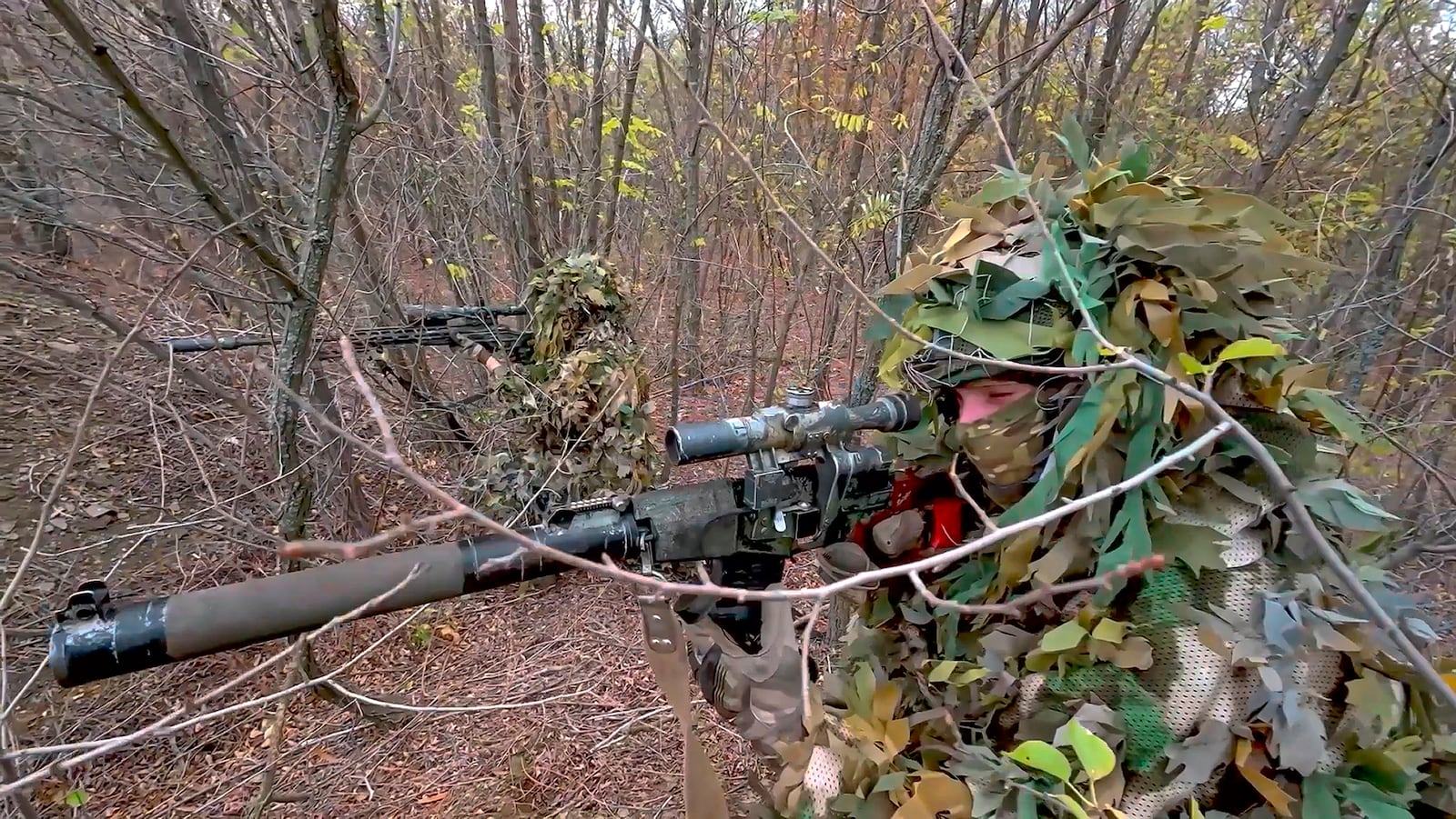 In this image made from video released by the Russian Defense Ministry on Thursday, Oct. 31, 2024, Russian snipers fire towards Ukrainian forces from an undisclosed location. (Russian Defense Ministry Press Service via AP)