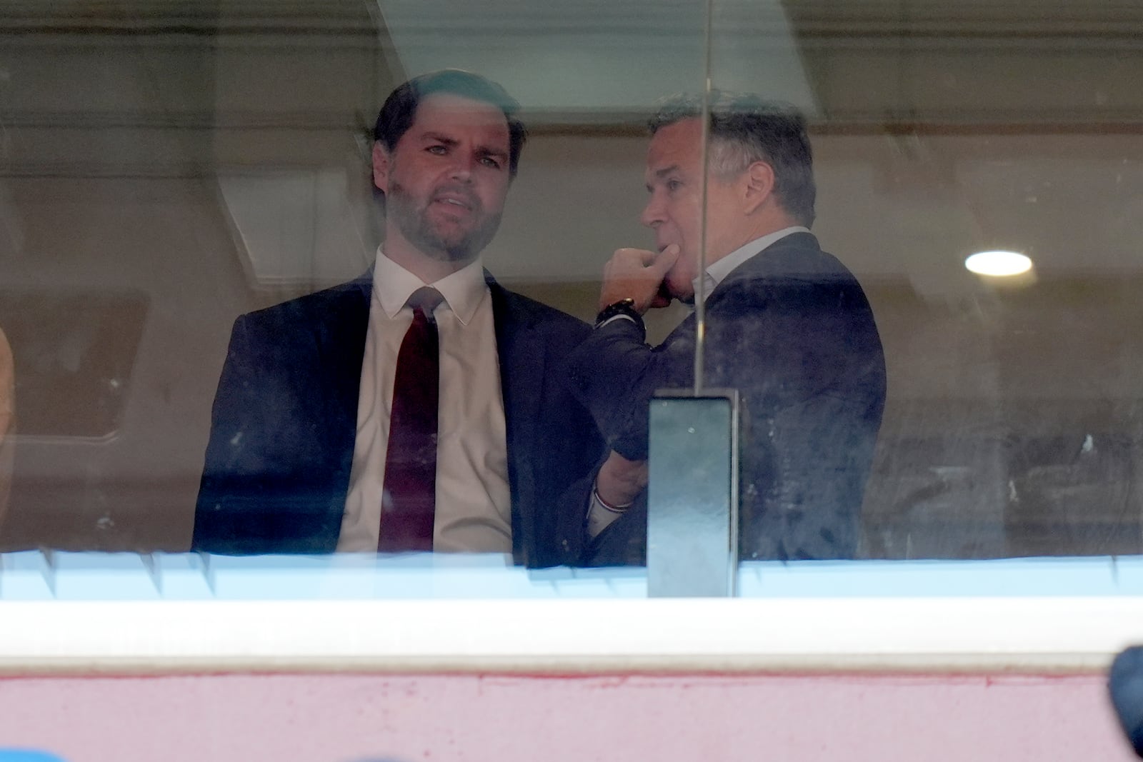 Vice President-elect JD Vance, left, and Senator-elect Dave McCormick, R-Pa., speak at the NCAA college football game between Army and Navy at Northwest Stadium in Landover, Md., Saturday, Dec. 14, 2024. (AP Photo/Stephanie Scarbrough)