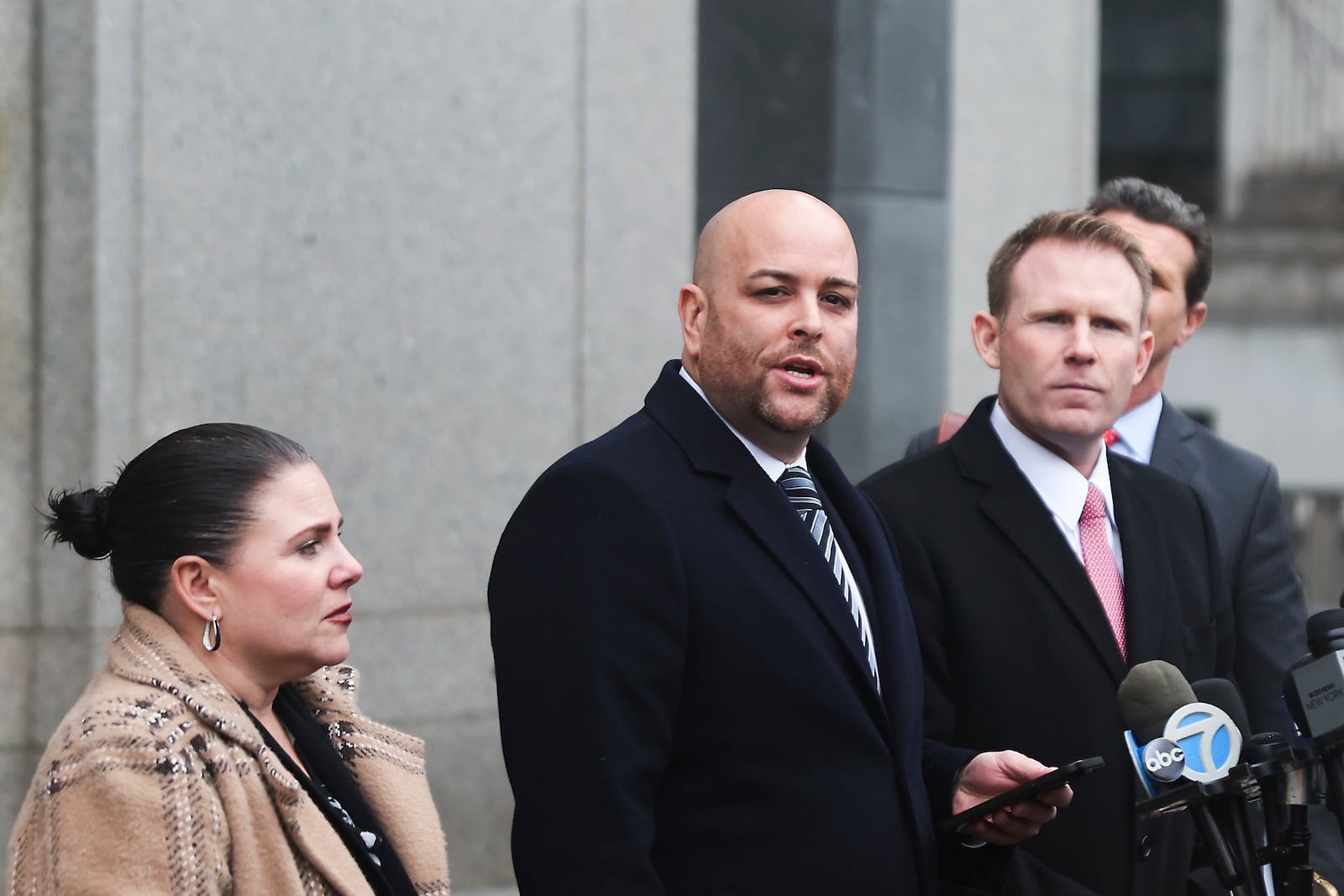 Attorney Joseph Cammarata, center, reads a statement off his phone on behalf of Rudy Giuliani outside of federal court, Thursday, Jan. 16, 2025, in New York. (AP Photo/Heather Khalifa)