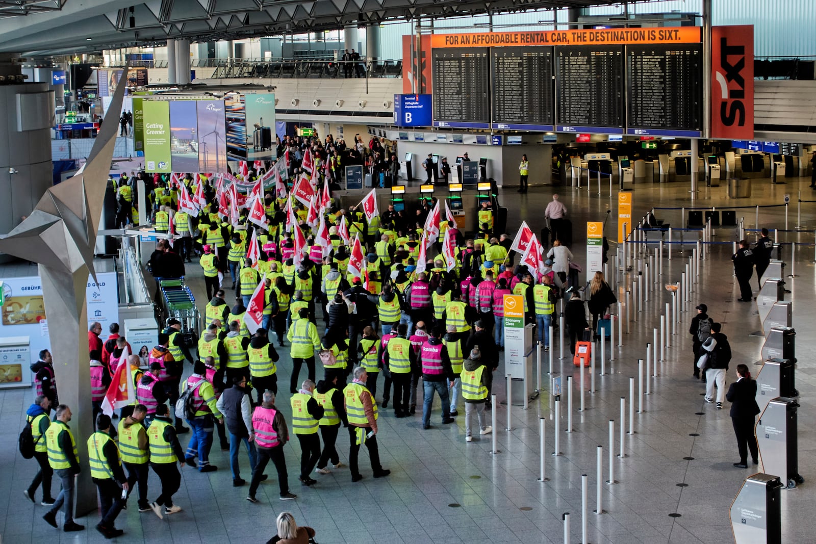 Airport employees organised in the Ver.di union walk through the airport in Frankfurt, Germany, Monday, March 10, 2025, when all major airports in Germany went on a warning strike. (AP Photo/Michael Probst)