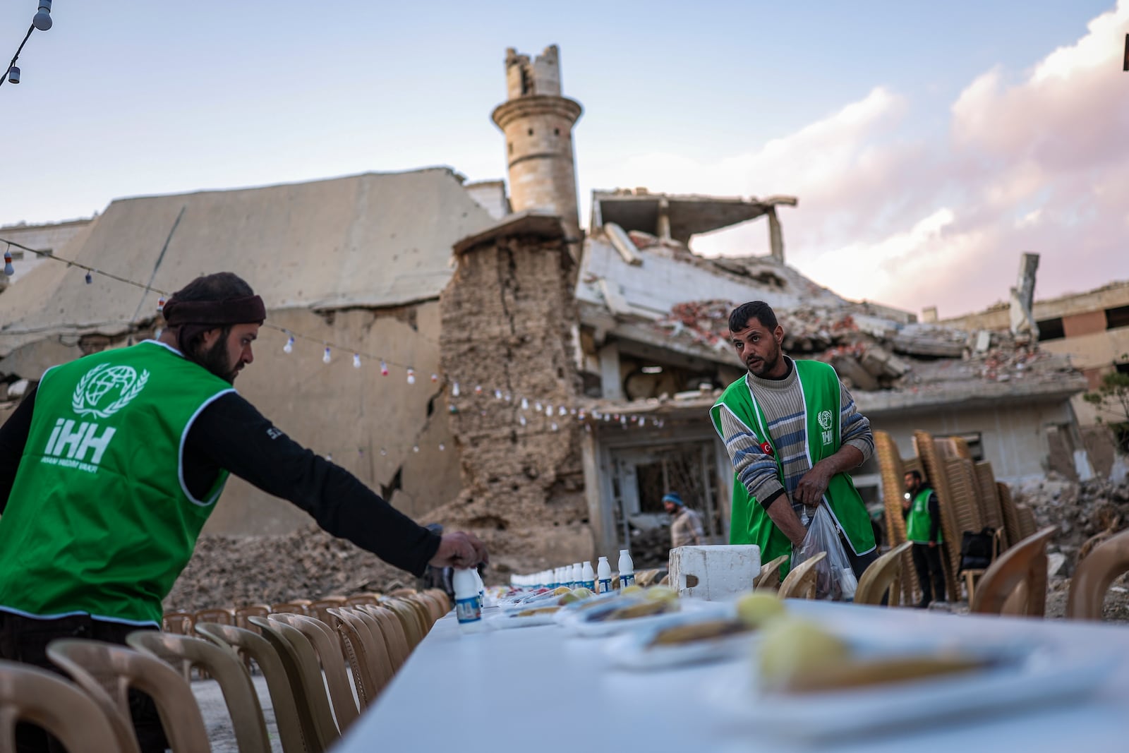 A table is prepared for iftar, the fast-breaking meal, organized by the Turkish Humanitarian Relief Foundation (IHH), on the first day of Ramadan in the Jobar neighborhood, which was devastated by the Syrian war, in Damascus, Syria, on Saturday, March 1, 2025.(AP Photo/Ghaith Alsayed)