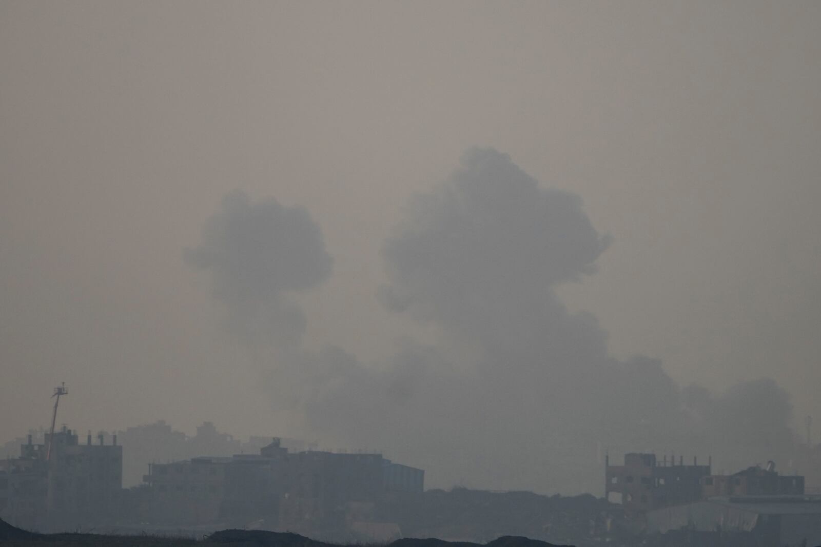 Smoke rises following an Israeli airstrike in the Gaza Strip, as seen from southern Israel, Thursday, Jan. 16, 2025. (AP Photo/Ariel Schalit)