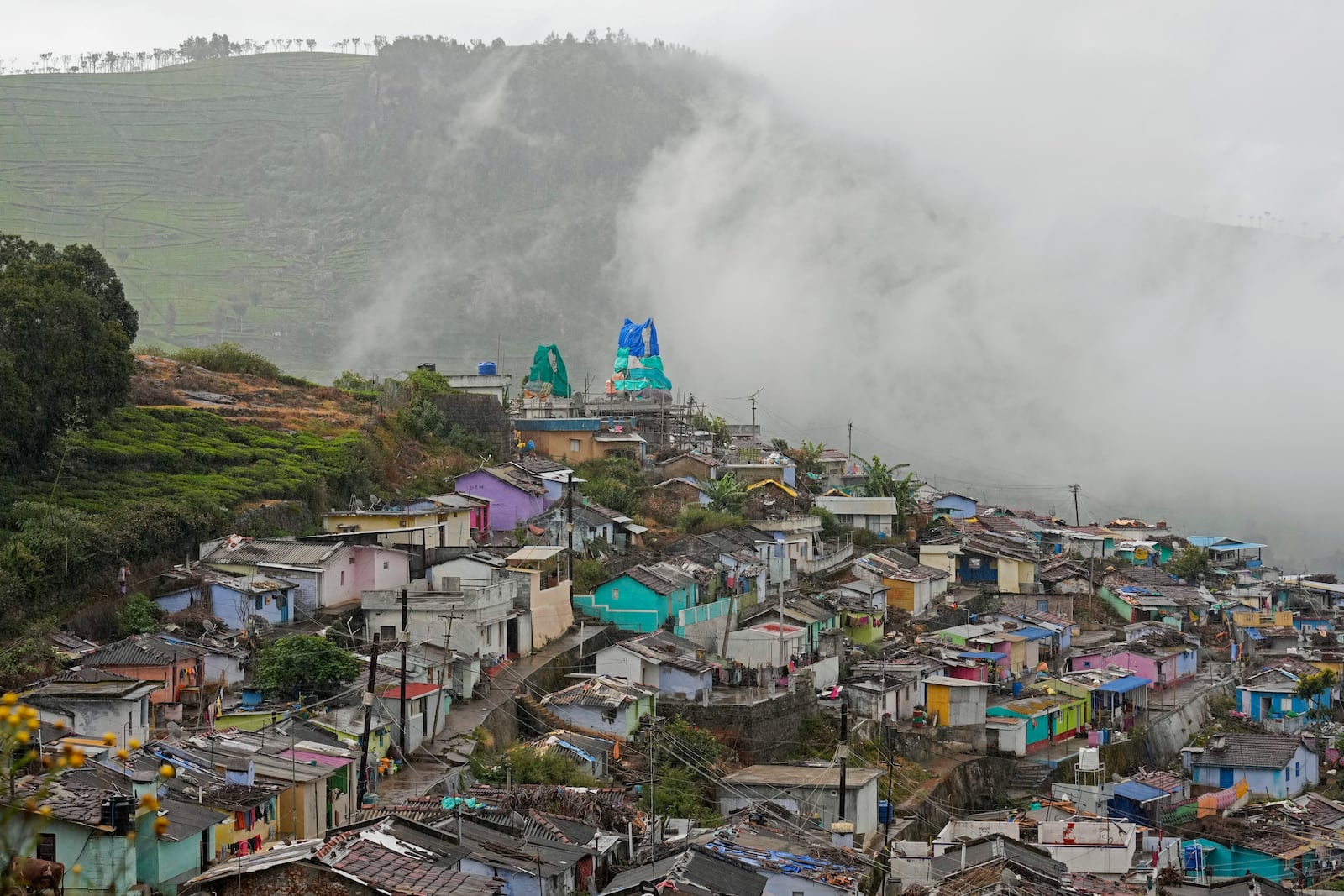 Mist covers the tea estates over a thickly populated area in Udhagamandalam in Nilgiris district, India, Thursday, Sept. 26, 2024. (AP Photo/Aijaz Rahi)