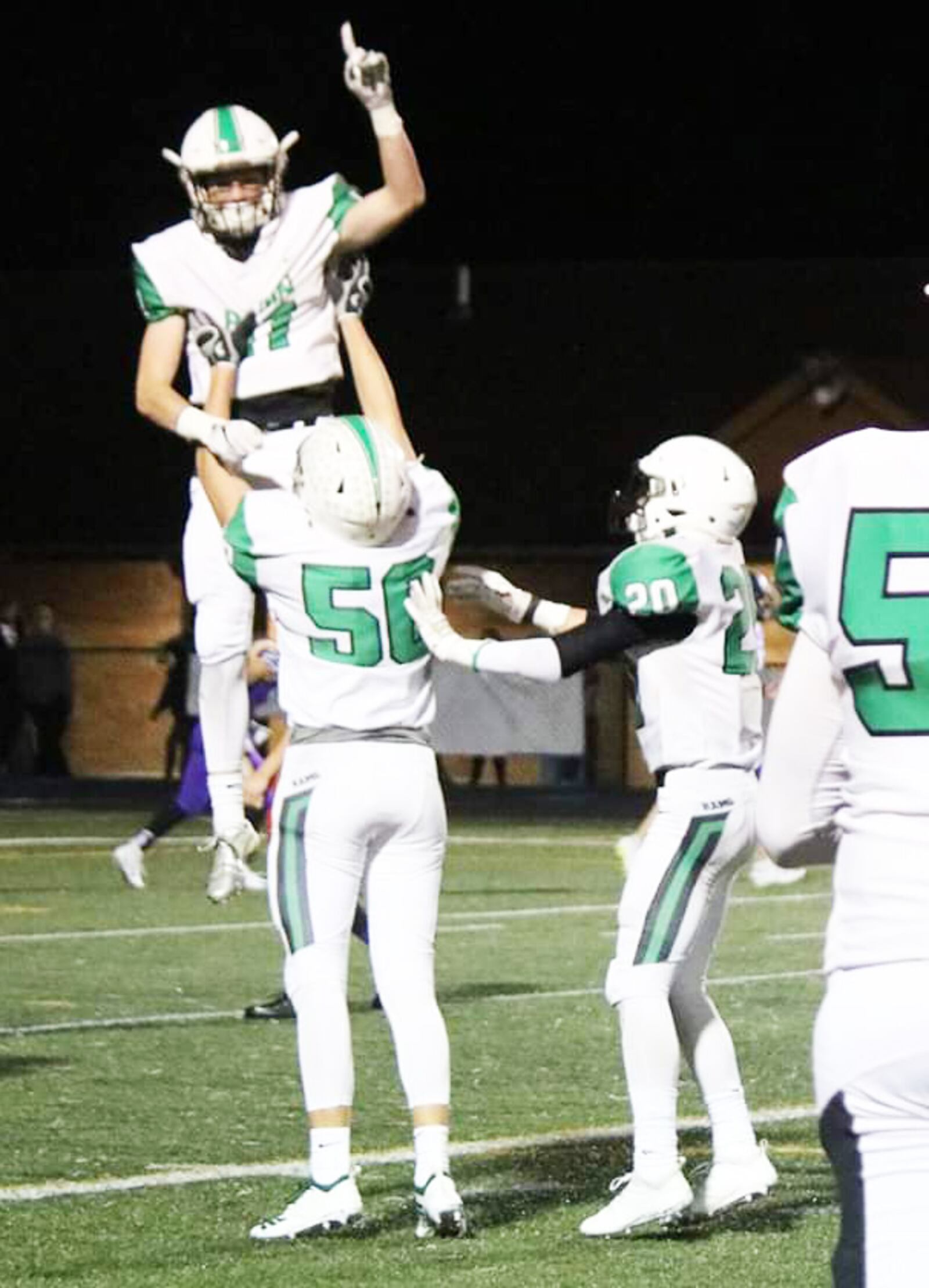 Badin's Josh Hegemann (11) celebrates with teammate John Berg (50) after returning a punt for a touchdown during last Friday's 33-22 win over Vandalia Butler in a Division III, Region 12 football playoff game at Memorial Field in Vandalia. CONTRIBUTED PHOTO BY TERRI ADAMS