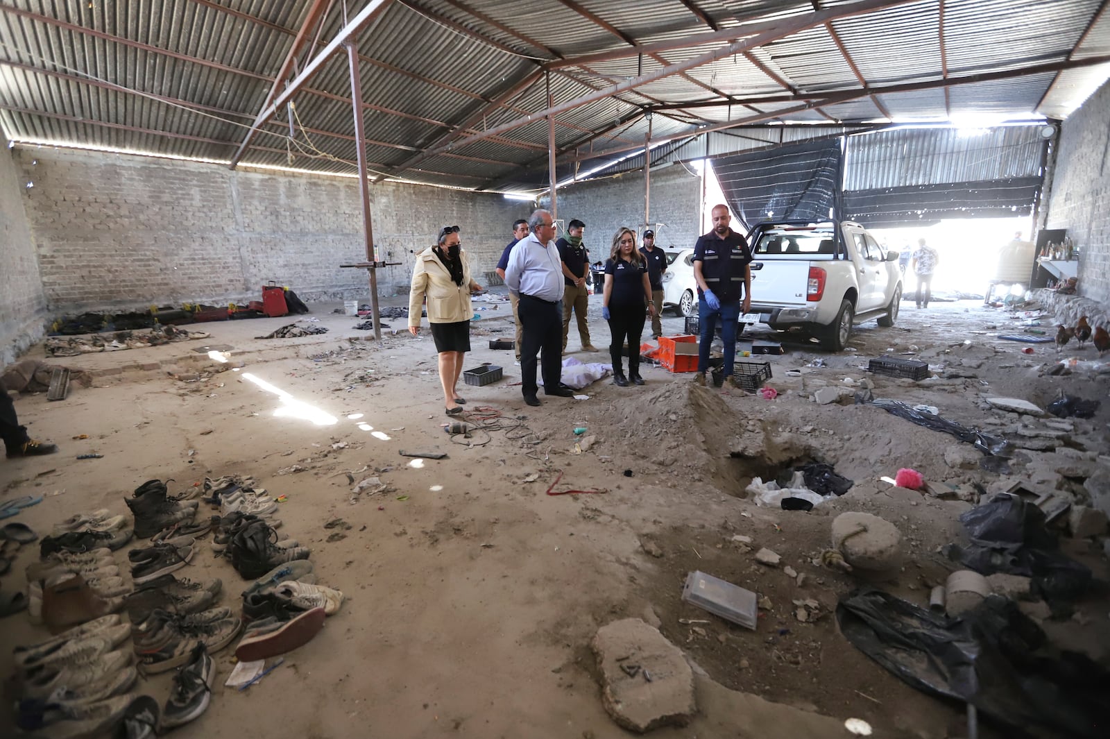 This photo released by the Jalisco State Attorney General's Office shows investigators inspecting the Izaguirre Ranch where skeletal remains were discovered in the municipality of Teuchitlan, Mexico, Tuesday, March 11, 2025. (Jalisco State Attorney General's Office via AP)