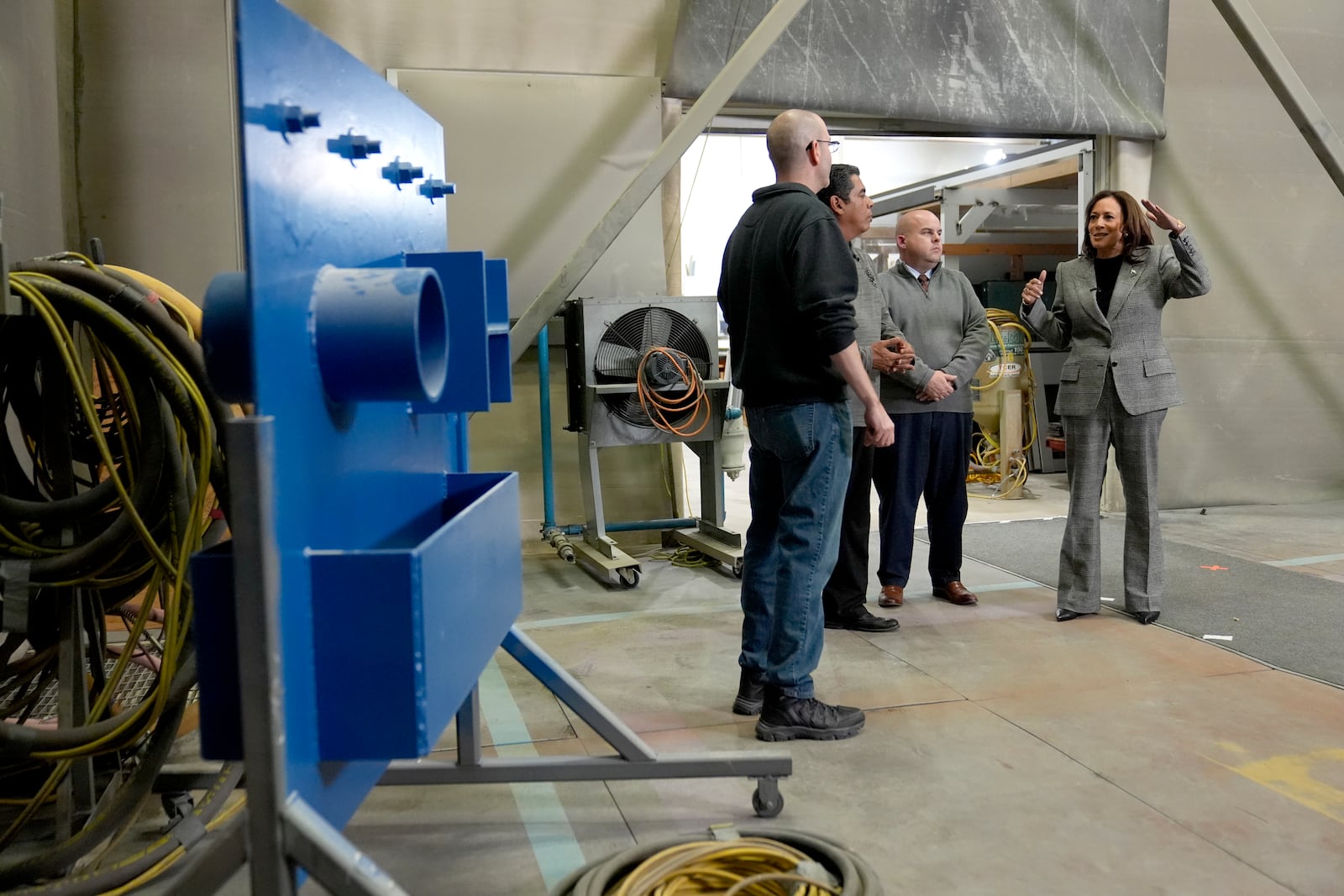 Democratic presidential nominee Vice President Kamala Harris, right, tours the International Union of Painters and Allied Trades District Council 1M facilities, Monday, Oct. 28, 2024, in Warren, Mich. (AP Photo/Paul Sancya)