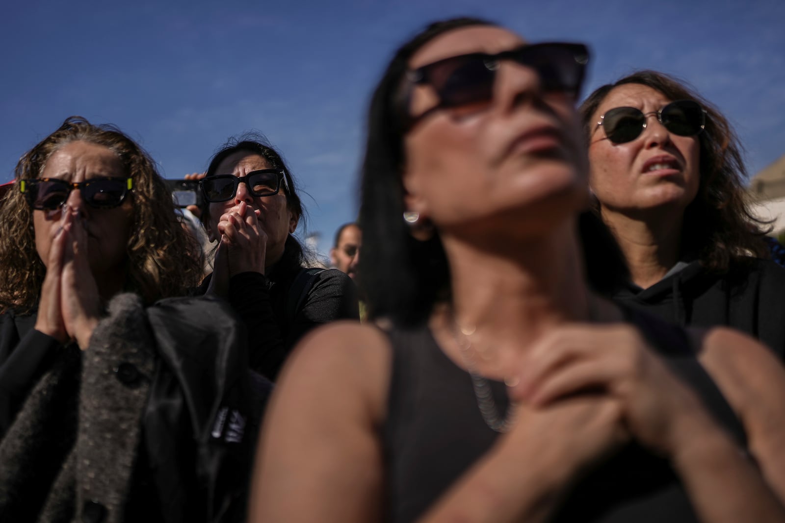 Israelis watch a live Gaza broadcast of the release of three Israeli hostages during a gathering at the so-called 'Hostages Square', in Tel Aviv, Israel, Saturday, Feb. 15, 2025. (AP Photo/Oded Balilty)