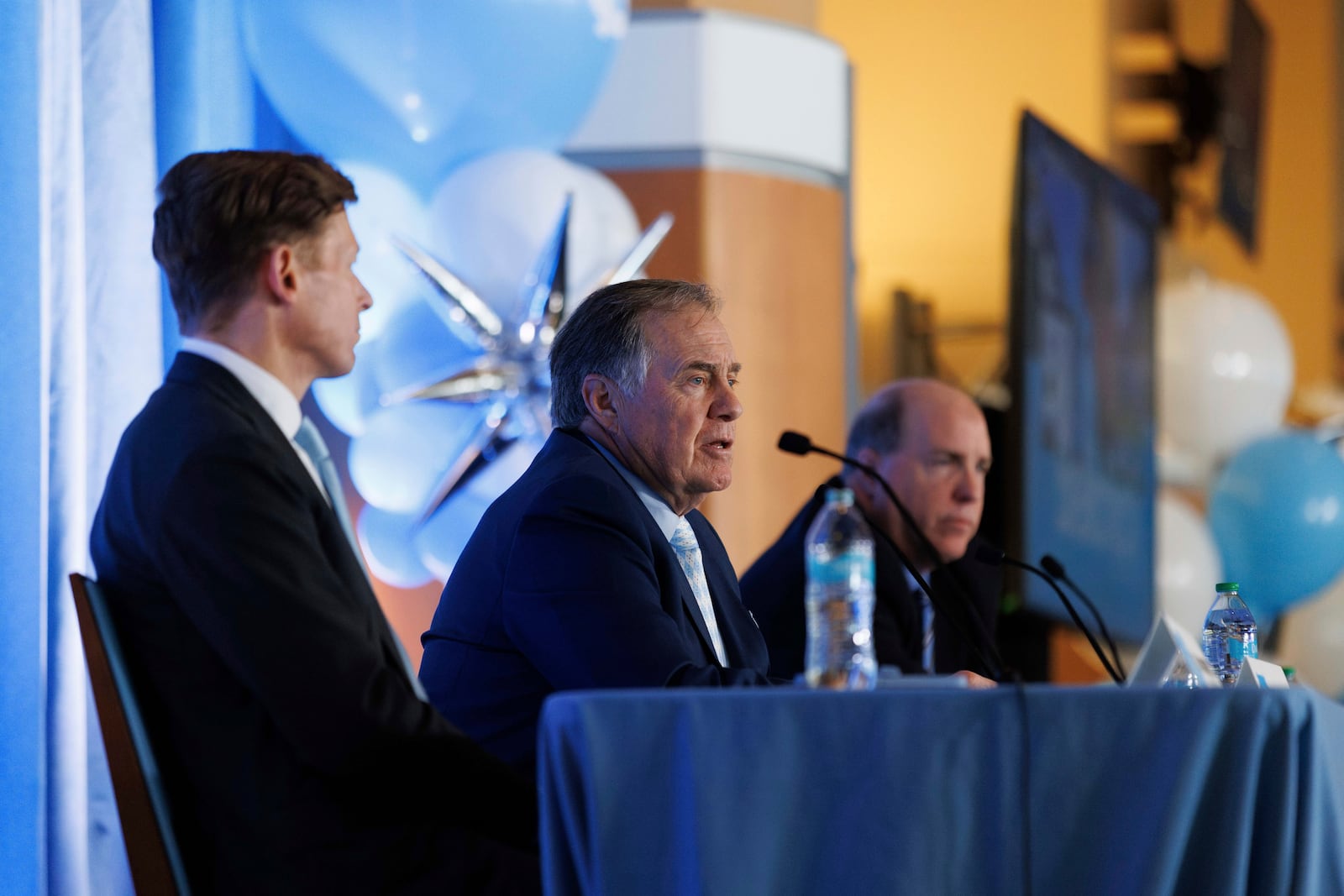 New North Carolina football coach Bill Belichick, center, speaks as University of North Carolina Chancellor Lee Roberts, left, and athletic director Bubba Cunningham, right, look on during an NCAA college football press conference in Chapel Hill, N.C., Thursday, Dec. 12, 2024. (AP Photo/Ben McKeown)