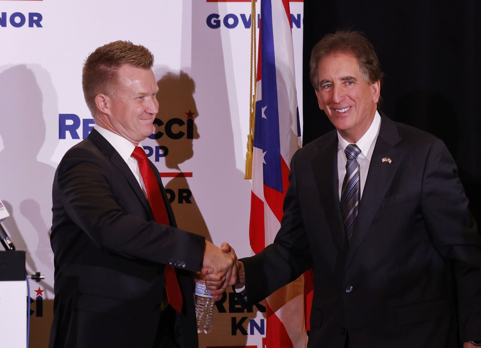 Springboro filmmaker Joe Knopp shakes hand with Ohio gubernatorial candidate Jim Renacci on Thursday, Dec. 2, 2021, at the Savannah Center in West Chester Twp. Renacci announced to a crowd of about 100 people Knopp will be his running mate. Renacci is challenging Ohio Gov. Mike DeWine in the May GOP primary. NICK GRAHAM/STAFF