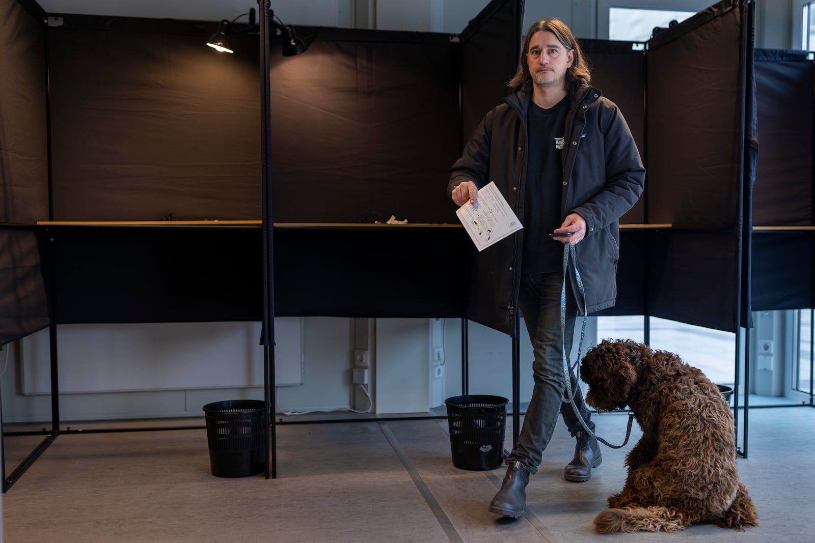 A man leaves the polling booth at a polling station during the advance voting in the second round of a parliamentary election in Vilnius, Lithuania, Tuesday, Oct. 22, 2024. (AP Photo/Mindaugas Kulbis)