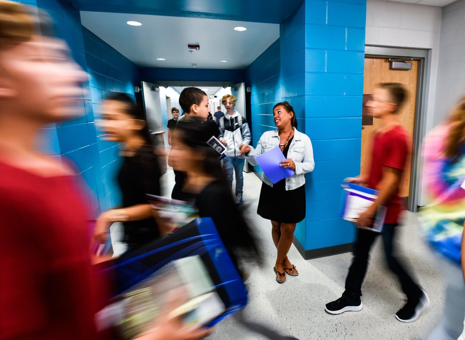 Intervention Specialist Dawn Schneider helps students find their classes in the hallway on the first day of classes at the new Fairfield Freshman School on Tuesday, Sept. 5, in Fairfield. 