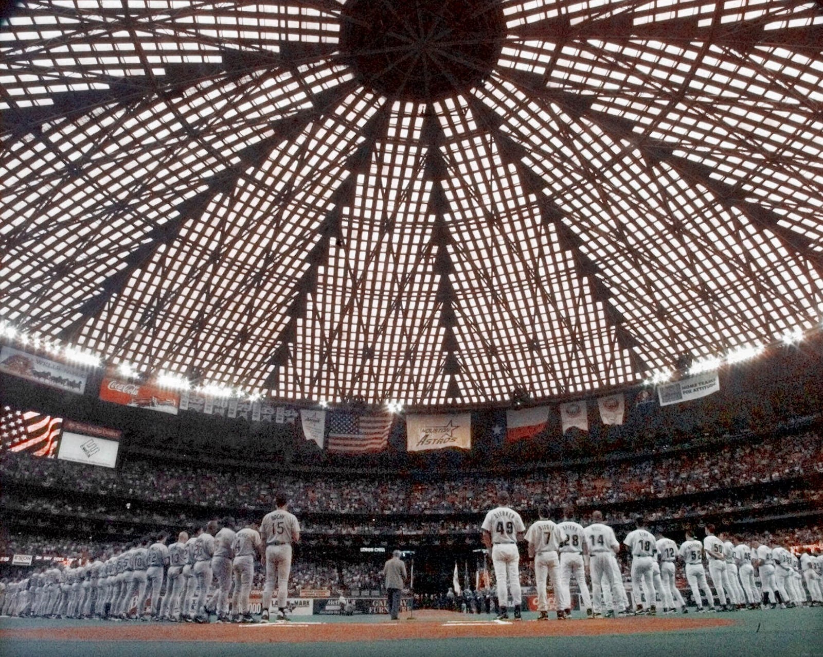 FILE- The San Diego Padres, left, and the Houston Astros, right, line up for the playing of the National Anthem before the first game of the National League division playoffs in the Houston Astrodome, Sept. 29, 1998. (AP Photo/David J. Phillip, File)