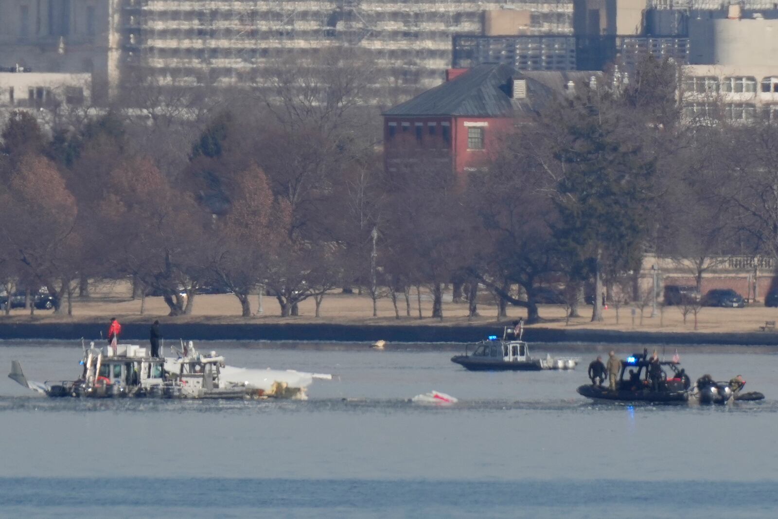 Search and rescue efforts are seen around a wreckage site in the Potomac River from Ronald Reagan Washington National Airport, early Thursday morning, Jan. 30, 2025, in Arlington, Va. (AP Photo/Carolyn Kaster)