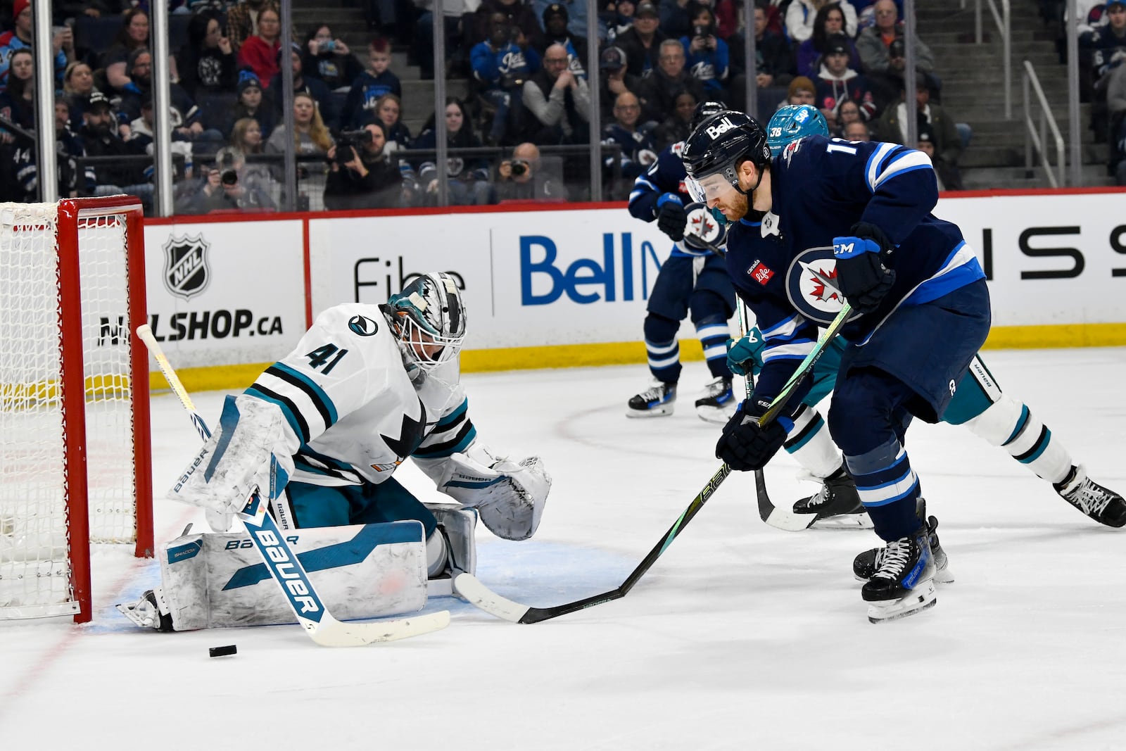 San Jose Sharks' goaltender Vitek Vanecek (41) makes a save on Winnipeg Jets' Gabriel Vilardi (13) during the second period of an NHL hockey game in Winnipeg, Manitoba, Monday, Feb. 24, 2025. (Fred Greenslade/The Canadian Press via AP)