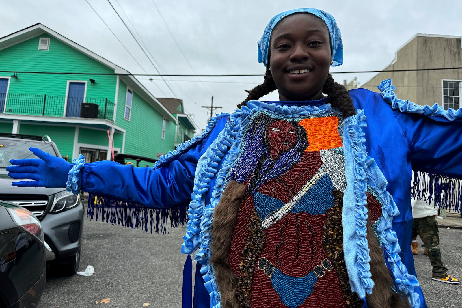 Jasmine Batiste, 28, a member of the Wild Magnolia tribe, shows off a handmade Black masking Indian costume she crafted using dental floss and beads on Mardi Gras Day, Tuesday, March 4, 2025 in New Orleans. (AP Photo/Jack Brook)