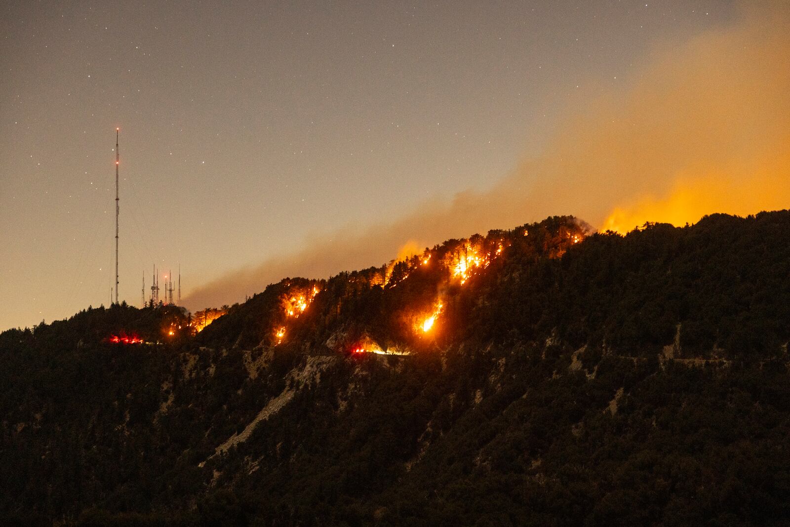 Spots of the Eaton Fire still burn after the fire swept through the mountains of the Angeles National Forest near Mount Wilson Observatory, north of Pasadena, Thursday, Jan. 9, 2025. (AP Photo/Etienne Laurent)