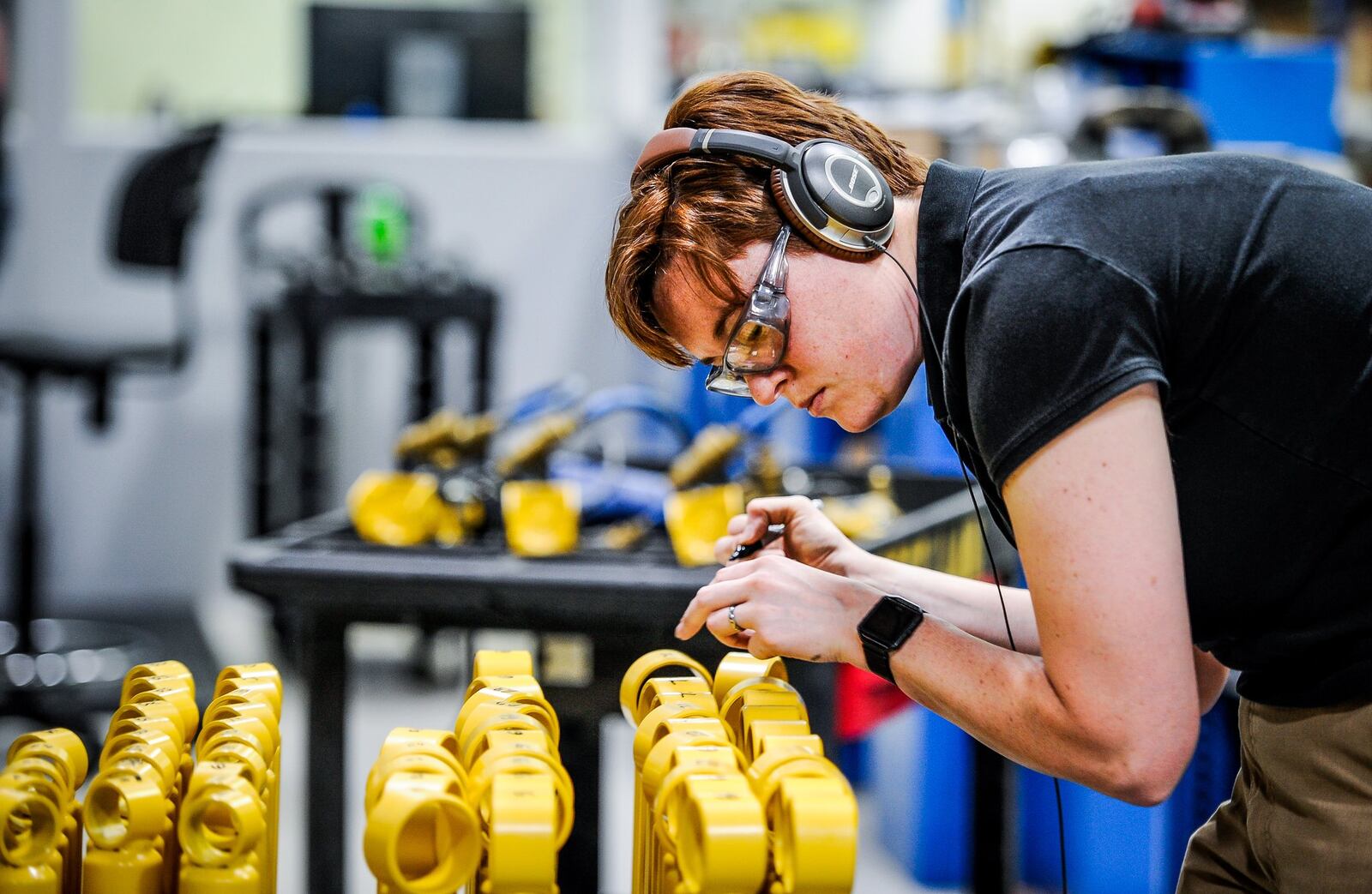 Validation engineer Heather Brooks checks shock absorbers in the testing area Thursday, April 20 at ThyssenKrupp Bilstein in Hamilton. 