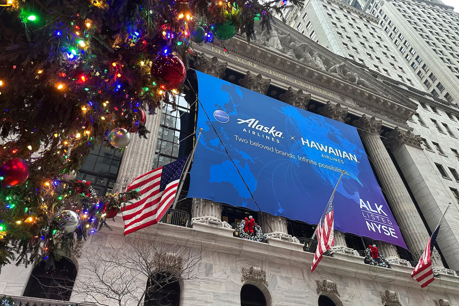 A banner for Alaska Air Group hangs on the front of the New York Stock Exchange in New York's Financial District on Tuesday, Dec. 10, 2024. (AP Photo/Peter Morgan, File)