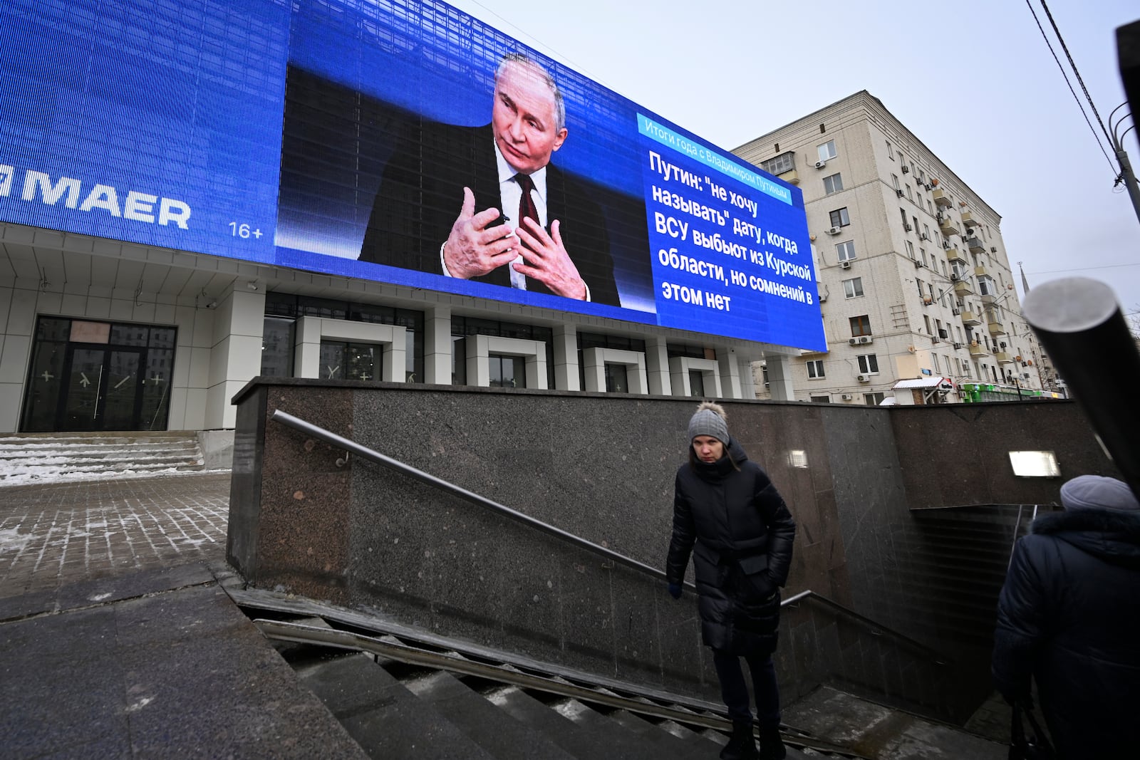 An electronic billboard on a building shows Russian President Vladimir Putin giving his annual news conference and call-in show in Moscow, Russia, Thursday, Dec. 19, 2024. (AP Photo/Dmitry Serebryakov)