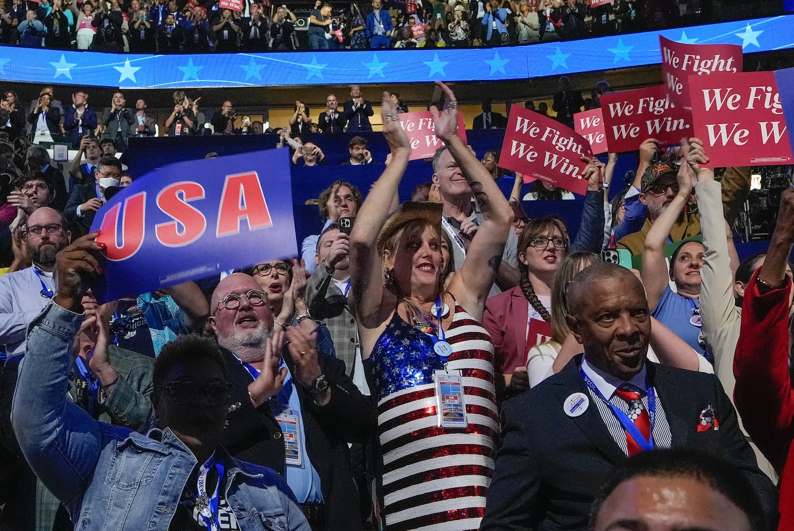 FILE - Jessie McGrath, center with hat, a transgender woman and a former Republican, cheers as she attends the Democratic National Convention as a delegate in Chicago, on Monday, Aug. 19, 2024. (AP Photo/Brynn Anderson, File)