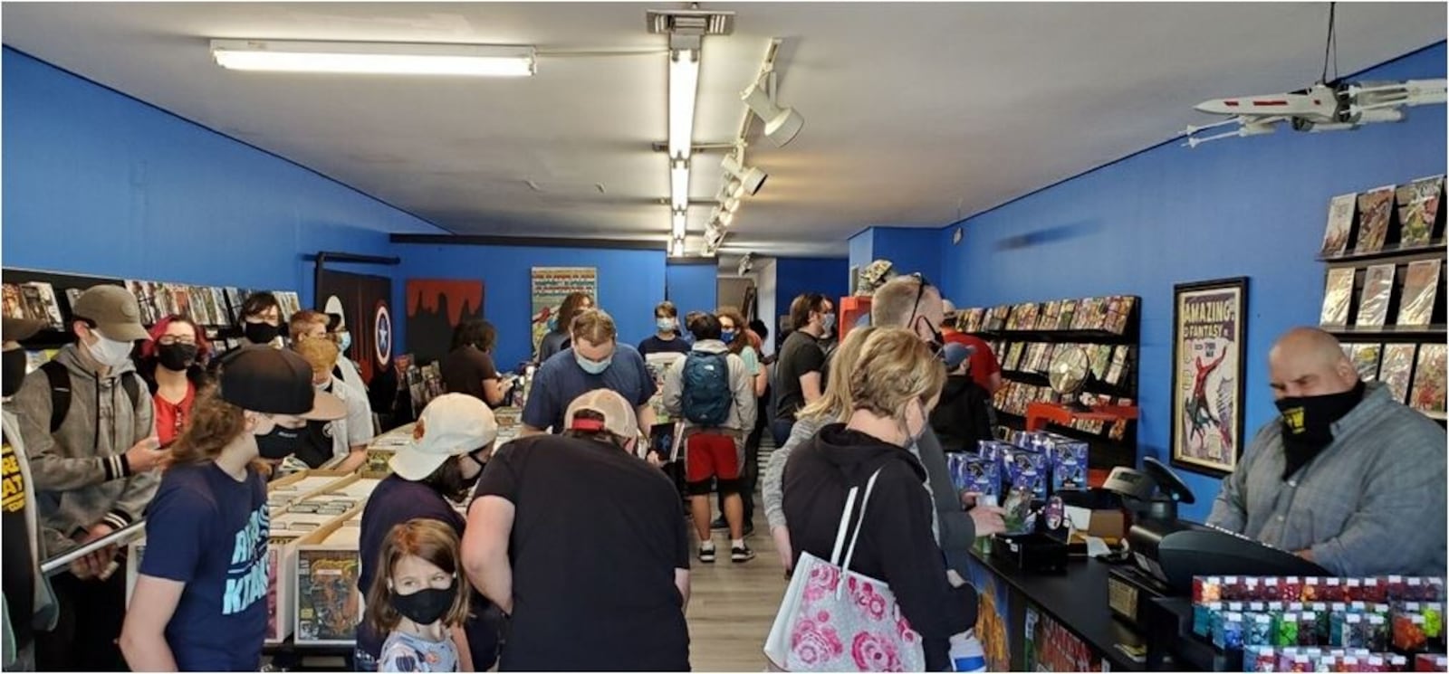 Brian LeVick, right, manning the cash register, the owner of Future Great Comics, opened his store in Oxford, after closing it in Hamilton, to a crowd. He has been pleased with the number of customers, even after most students have left for the summer. PROVIDED