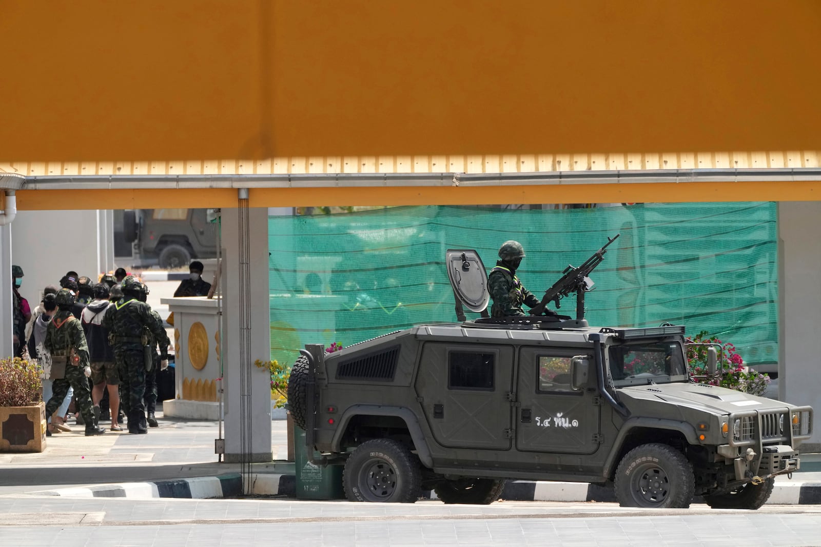 Thai soldiers provide security for Indonesian nationals being sent home after being forced to work at scam centers in eastern Myanmar in Mae Sot, Thailand on Thursday, Feb. 27, 2025. (AP Photo/Sakchai Lalit)