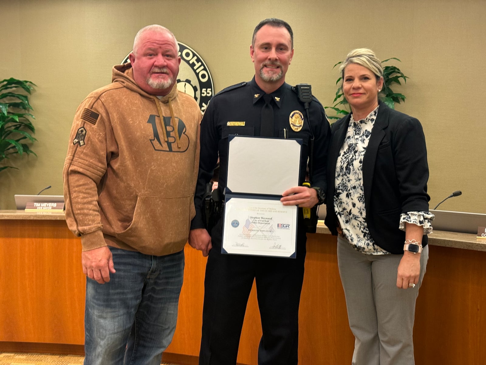 Fairfield Police Chief Steve Maynard receives the Patriot Award from Department of Defense’s Employer Support of the Guard and Reserve Award. He was nominated by Officer Trey King who is deployed overseas with his unit of the Kentucky National Guard. Maynard, center, is pictured with King's parents, retired Fairfield officer Ralph King (left) and Detective Ellie King. MICHAEL D. PITMAN/STAFF