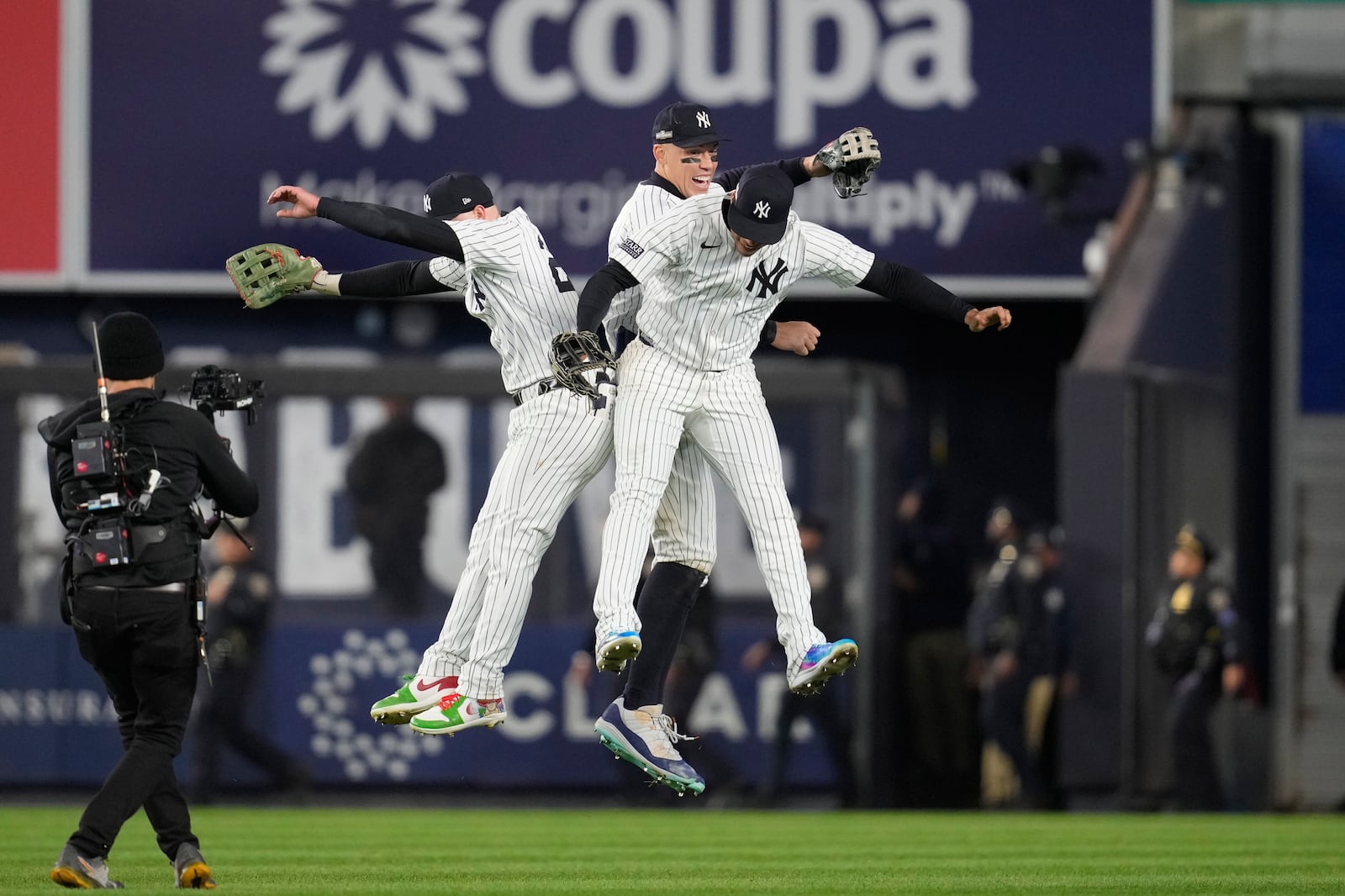 From left to right, Alex Verdugo, Aaron Judge and Juan Soto celebrate after Game 1 of the baseball AL Championship Series against the Cleveland Guardians Monday, Oct. 14, 2024, in New York. The Yankees won 5-2. (AP Photo/Godofredo Vásquez)