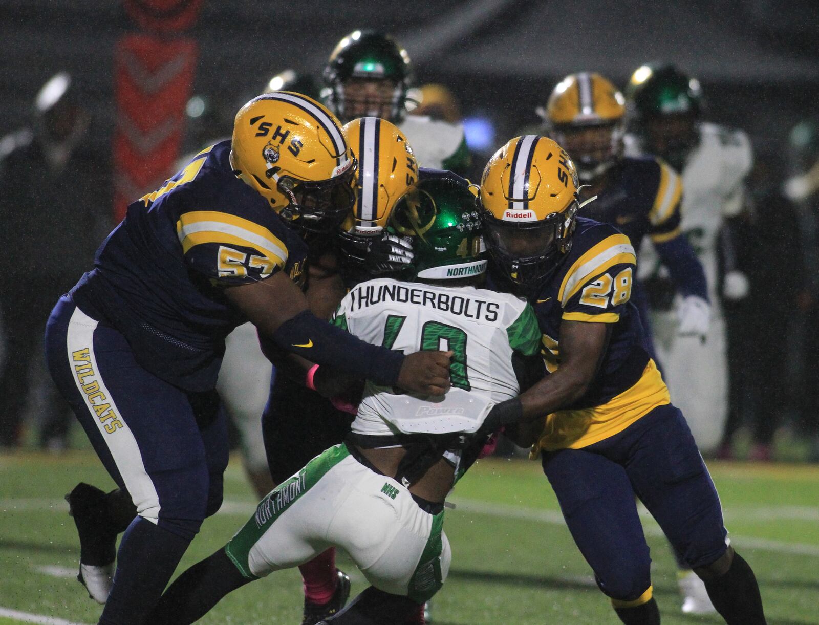 Springfield's Tywan January, left, Jokell Brown, back center, and Jaivian Norman, right, tackle Northmont's Bryant Callahan on Friday, Oct. 22, 2021, at Springfield. David Jablonski/Staff