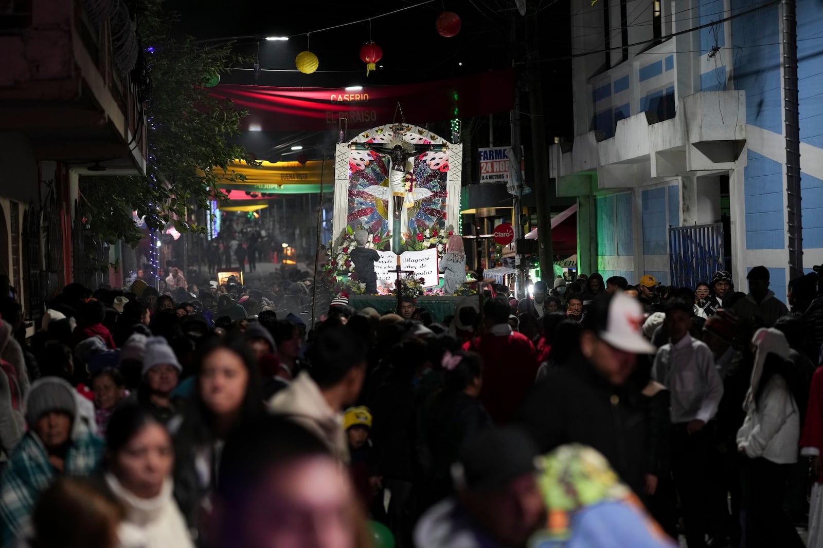 Catholics hold a procession with a replica of the Statue of the Black Christ of Esquipulas the night before its feast day in Esquipulas Palo Gordo, in Guatemala's San Marcos department, Tuesday, Jan. 14, 2025. (AP Photo/Moises Castillo)