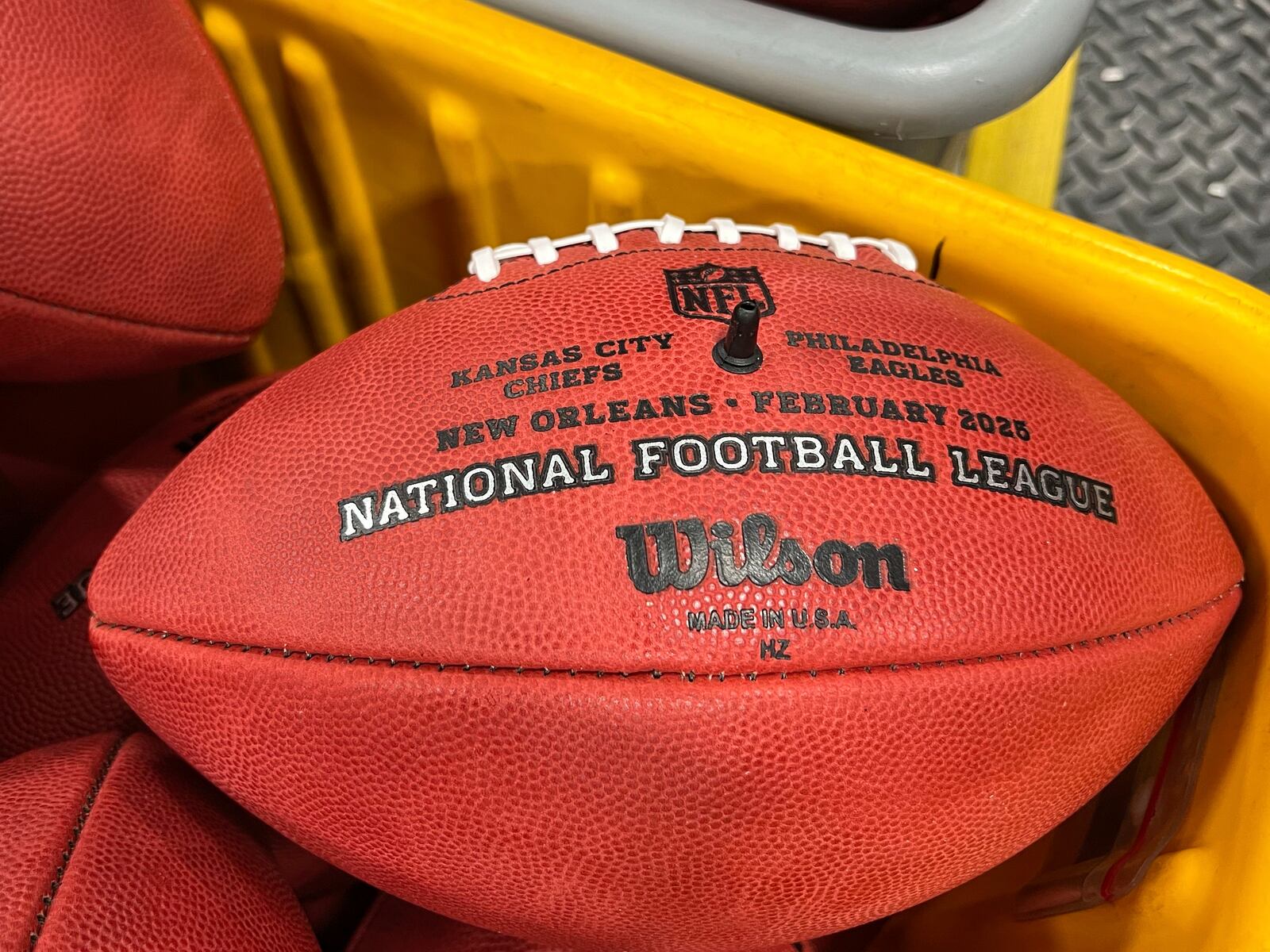 A bin of official balls for the NFL Super Bowl football game wait to be shipped inside the Wilson Sporting Goods football factory, Monday, January 27, 2025, in Ada, Ohio. (AP Photo/Patrick Aftoora-Orsagos)