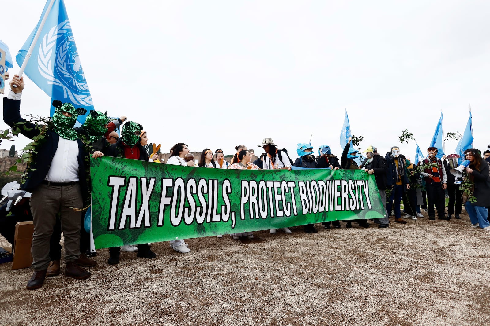 Climate demonstrators take part in a protest holding a sign that reads "tax fossils, protect biodiversity" as the COP16 biodiversity conference continues on Tuesday, Feb. 25, 2025, in Rome. (Cecilia Fabiano/LaPresse via AP)