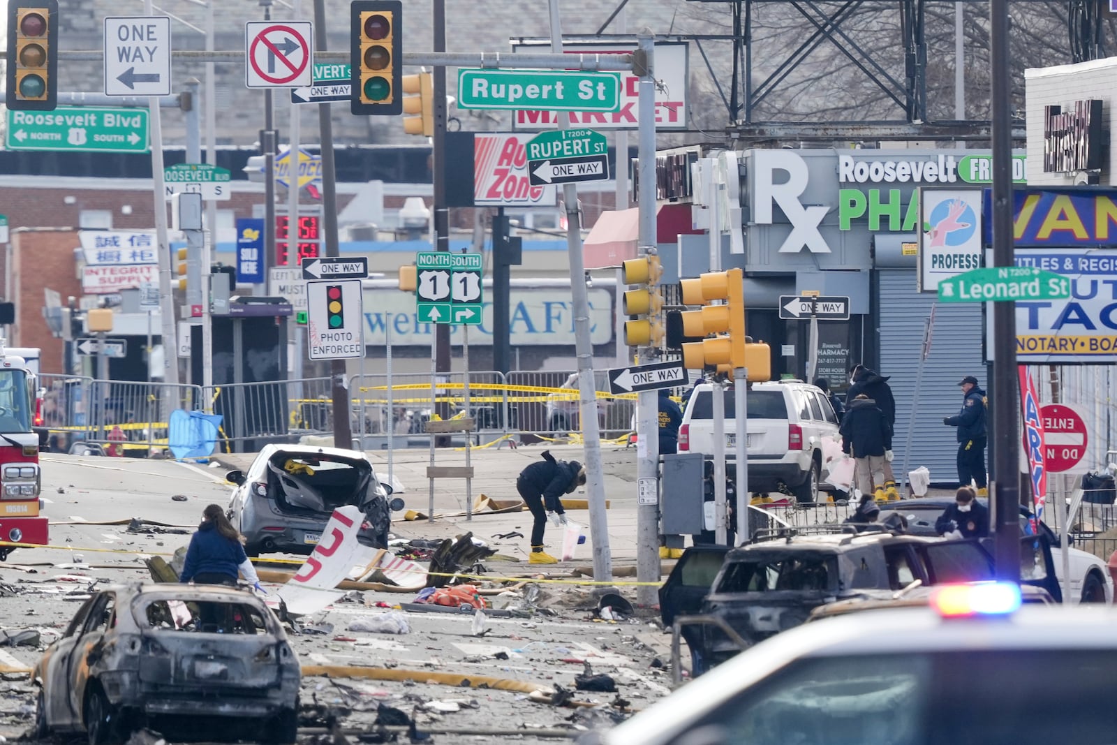 Investigators work the scene after a small plane crashed in Philadelphia, Saturday, Feb. 1, 2025. (AP Photo/Matt Rourke)