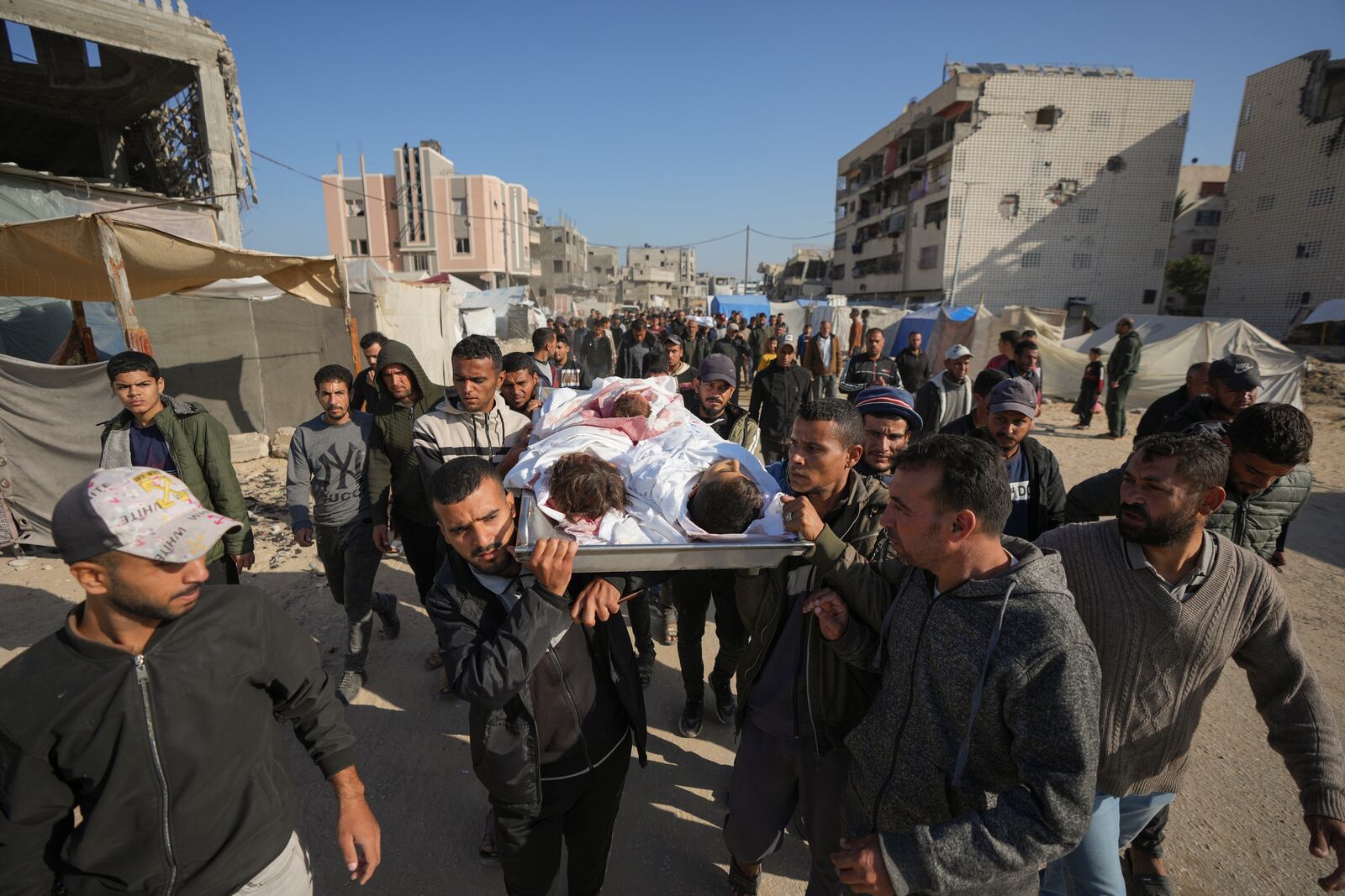 The bodies of three children are carried for burial in Deir al-Balah, Gaza Strip, Thursday Nov. 21, 2024. Seven-year-old Hamza, his five-year-old brother Abdelaziz, and his four-year-old sister Laila Hassan were among 9 people killed by an Israeli strike in Khan Younis on Wednesday. Palestinian health officials say the death toll in the Gaza Strip from the 13-month-old war between Israel and Hamas has surpassed 44,000. (AP Photo/Abdel Kareem Hana)