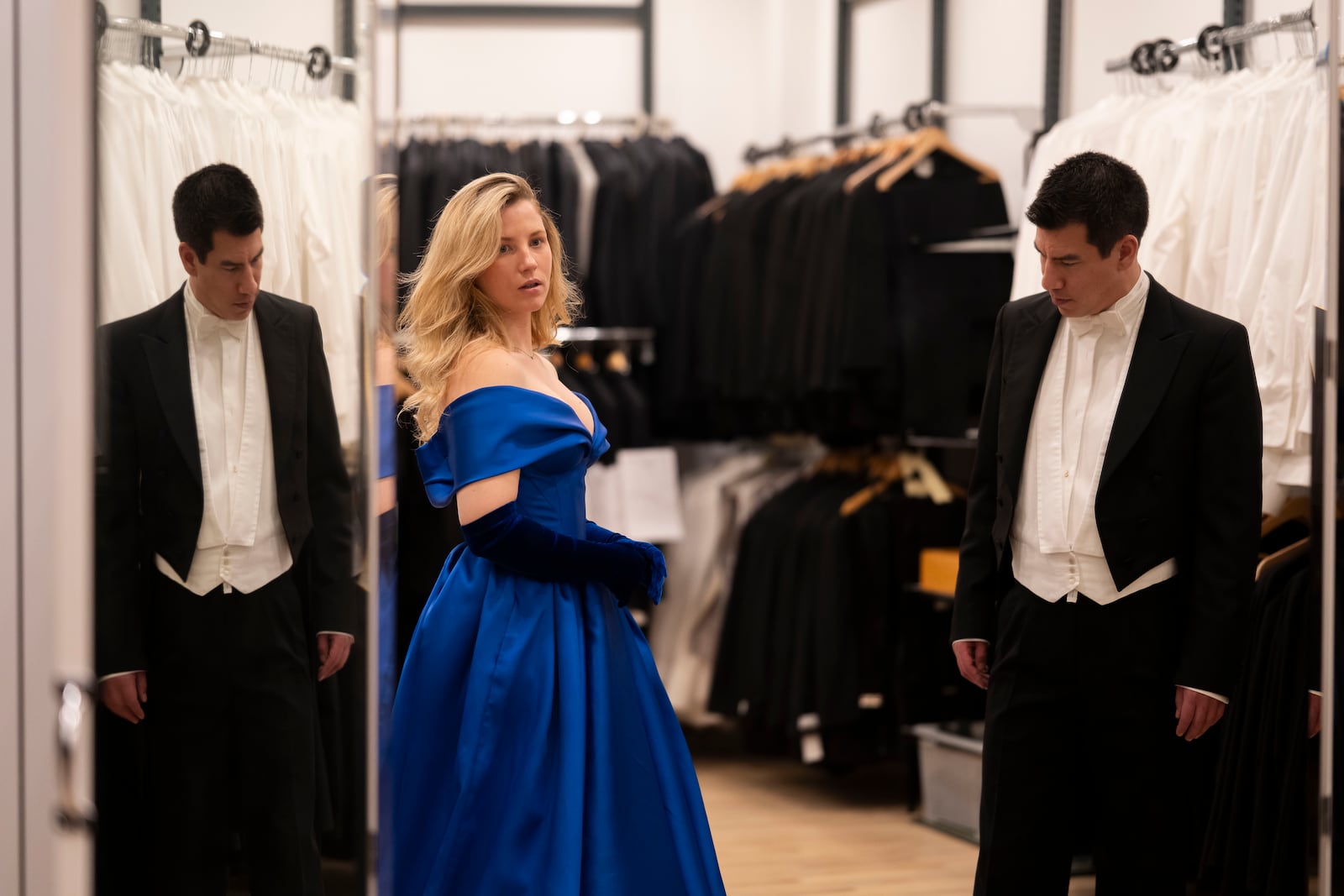 A young couple watch themselves in the mirror during their fitting in Lambert Hofer, a renowned costume workshop in Vienna, Austria, Wednesday, Febr 26, 2025. (AP Photo/Denes Erdos)