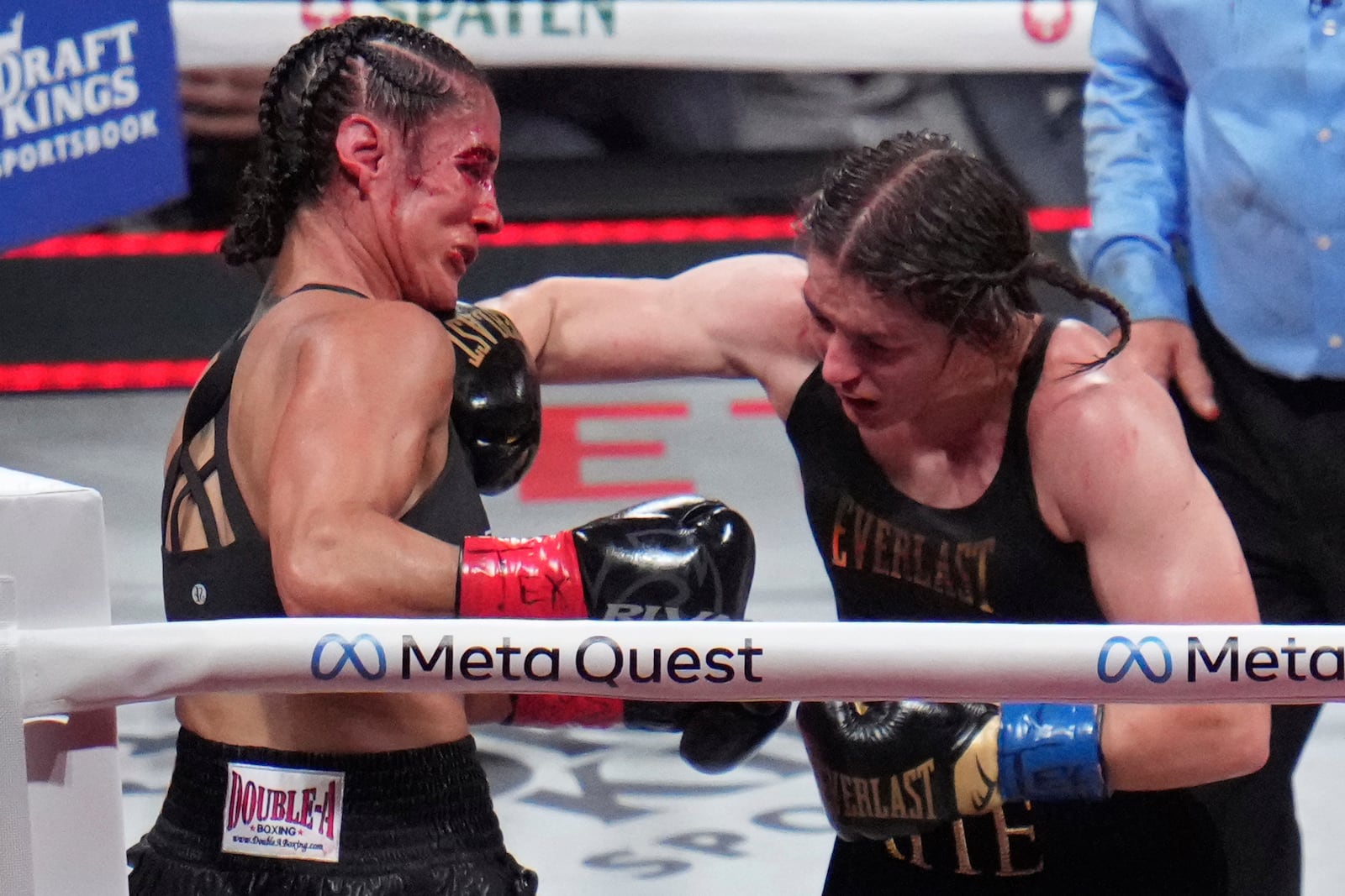 Katie Taylor, right, hits Amanda Serrano during their undisputed super lightweight title bout, Friday, Nov. 15, 2024, in Arlington, Texas. (AP Photo/Julio Cortez)