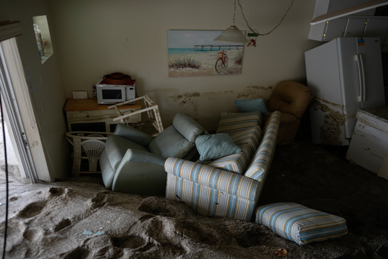 Several feet of sand fills a condo following the passage of Hurricane Milton, at YCA Vacation Rental in Venice, Fla., Friday, Oct. 11, 2024. (AP Photo/Rebecca Blackwell)