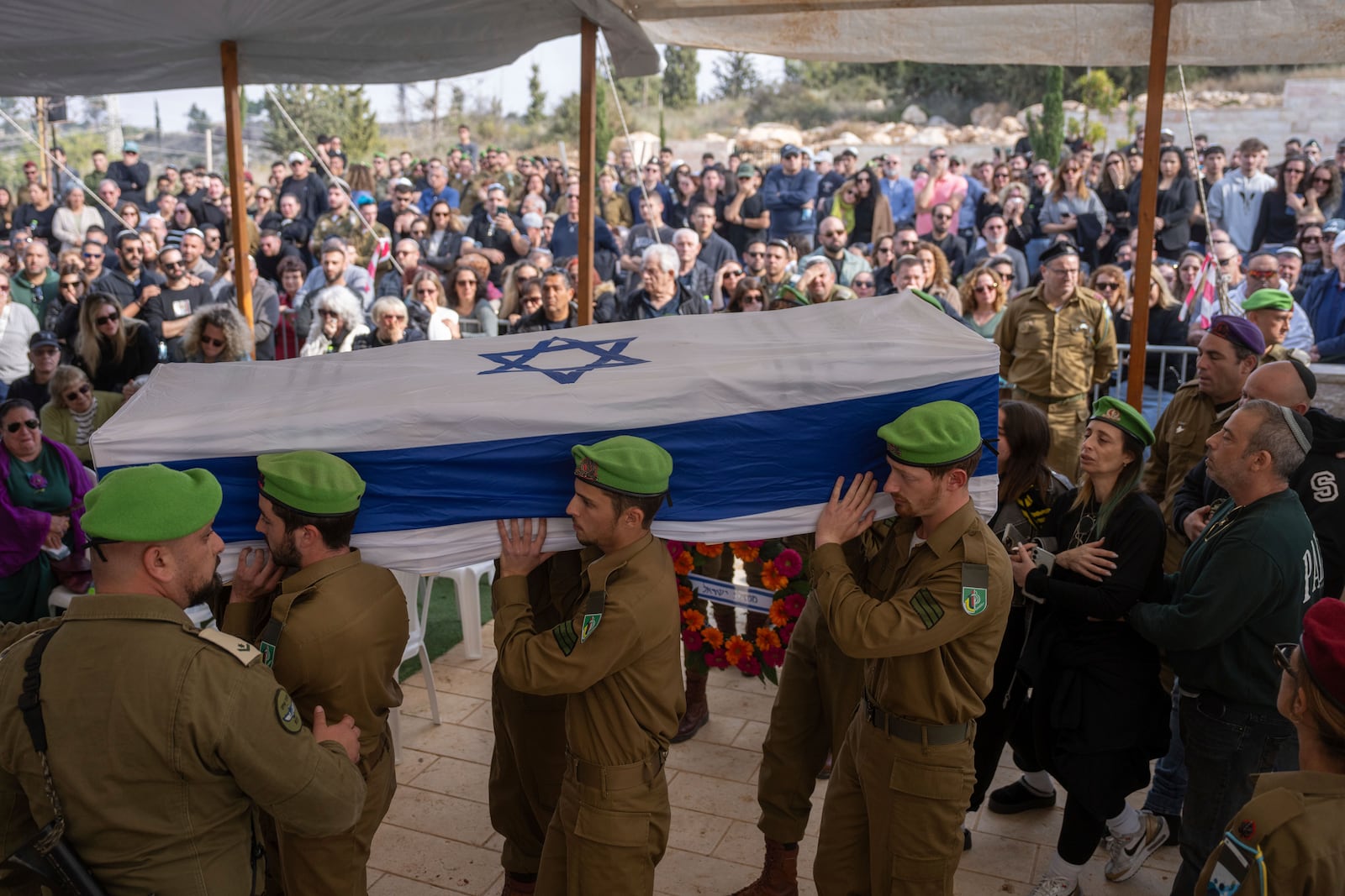 Israeli soldiers and relatives carry the flag-draped casket of Sergeant Yahav Maayan, who was killed in combat in the Gaza Strip, during his funeral at a military cemetery in Modiin, Israel, Sunday, Jan. 12, 2025. (AP Photo/Ohad Zwigenberg)