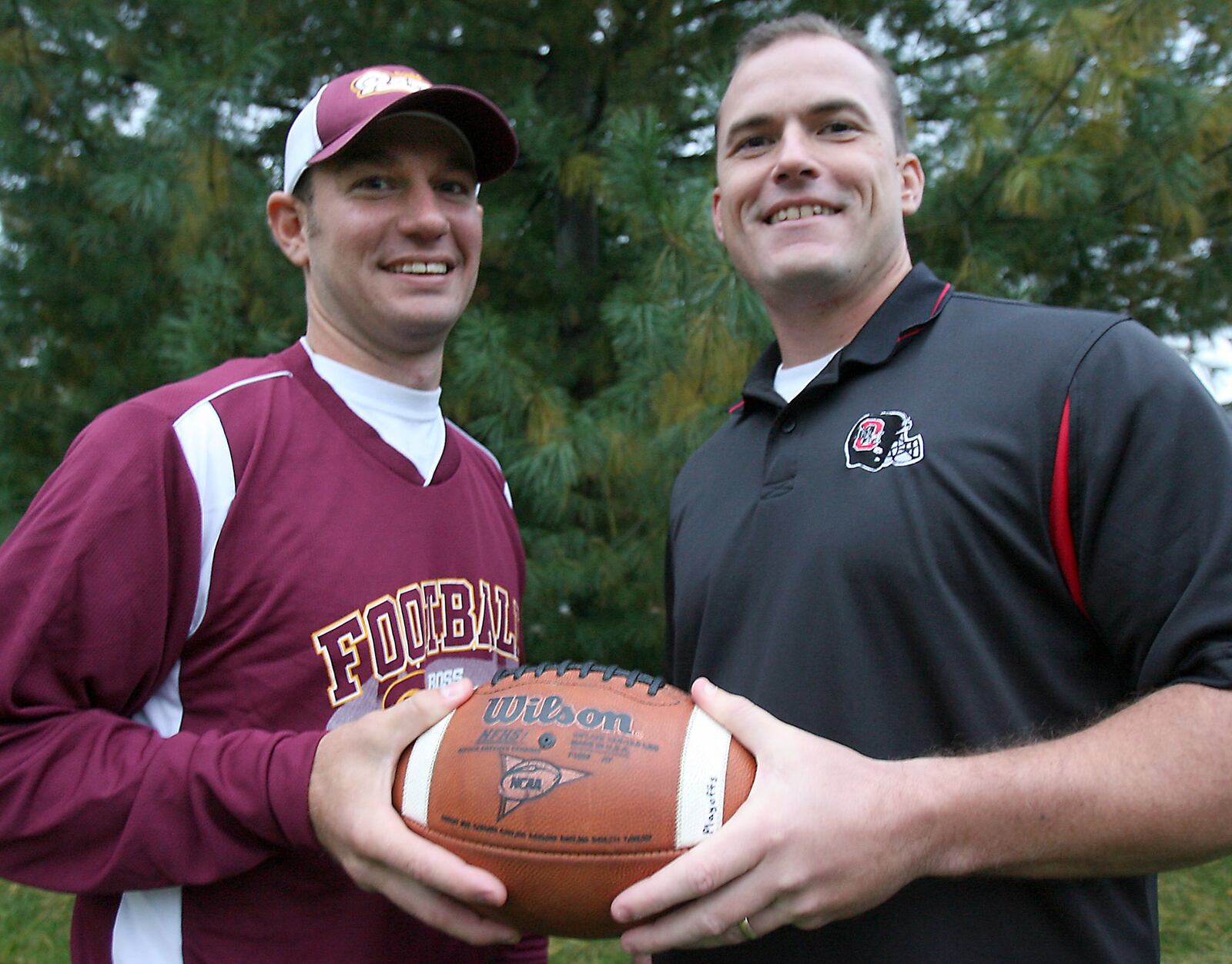 Nick Yordy (left) and Jeremy Rogers (right) get together for a photo in 2009, one season after leaving New Miami. Yordy was the offensive coordinator at Ross and Rogers was the defensive coordinator at Mount Healthy, and they were preparing to face each other for the first time. JOURNAL-NEWS FILE PHOTO