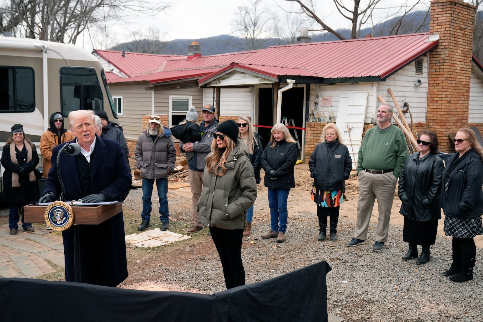 President Donald Trump speaks along side first lady Melania Trump, as they meet with homeowners affected by Hurricane Helene in Swannanoa, N.C., Friday, Jan. 24, 2025. (AP Photo/Mark Schiefelbein)