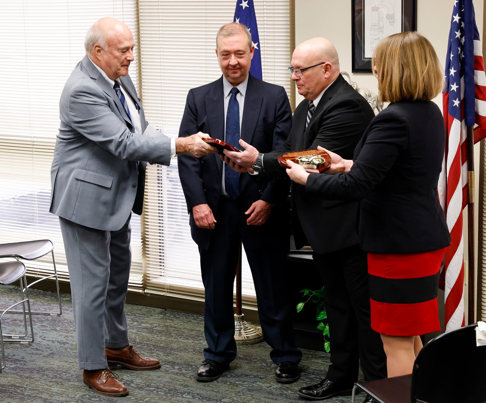 Butler County prosecutor Mike Gmoser, left, and former Butler County assistant prosecuting attorney and now Bar Council for the Ohio State Bar Association Kelly Heile, right, present Middletown Division of Police detectives Tom McIntosh, second from left, and Jon Hoover the Butler County Prosecutor's 5th Annual Meritorious Service Award in recognition of their outstanding police work for the case involving the death of 6-year-old James Robert Hutchinson of Middletown. NICK GRAHAM / STAFF