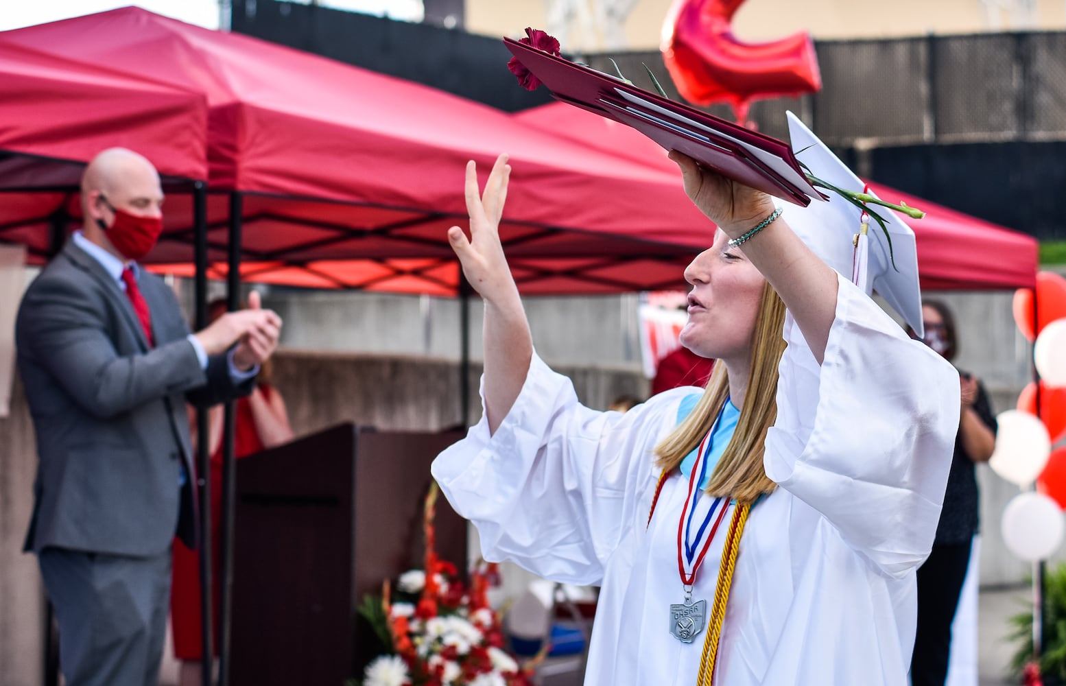 Madison High School drive-thru graduation ceremony at Land of Illusion