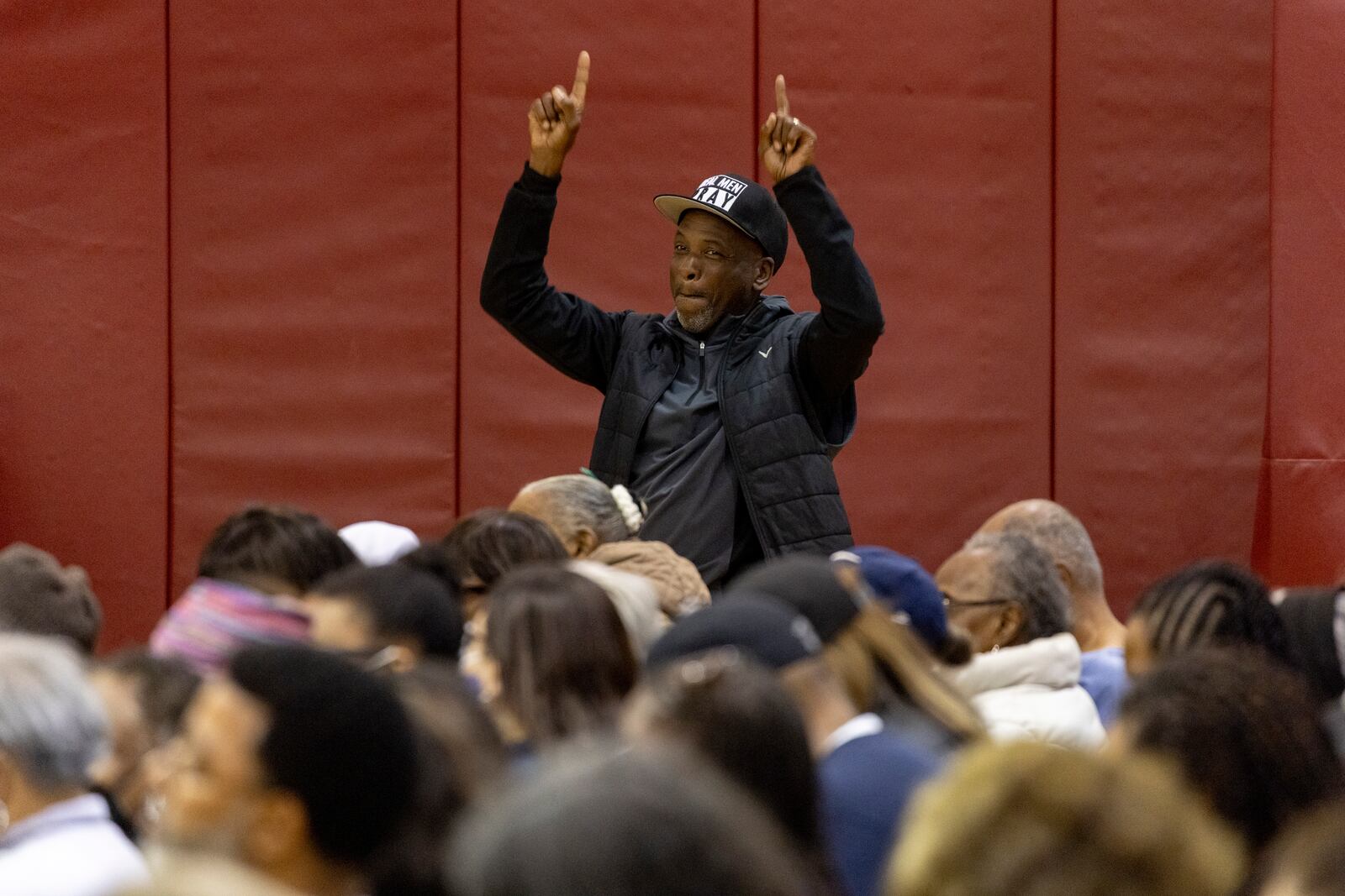 A member of the audience reacts as people impacted by the Eaton Fire attend an event at the gymnasium of Pasadena City College where The Change Reaction will be handing out about 1,000 checks of between $2,500-$5,000, Tuesday, Jan. 28, 2025 in Pasadena, Calif. (AP Photo/Etienne Laurent)