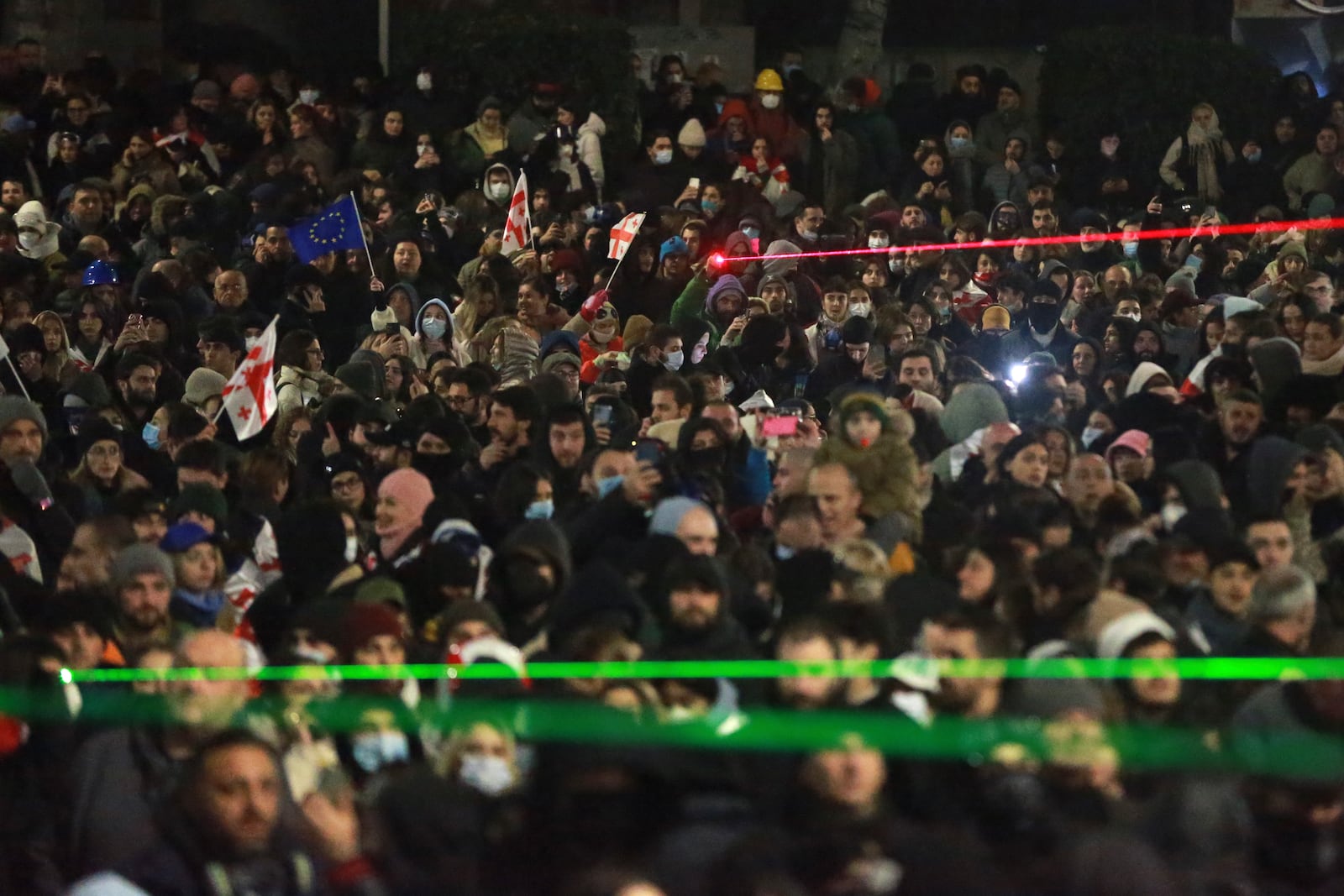 Demonstrators use lasers against the police blocking the way during a rally outside the parliament's building to protest the government's decision to suspend negotiations on joining the European Union for four years in Tbilisi, Georgia, on Saturday, Nov. 30, 2024. (AP Photo/Zurab Tsertsvadze)