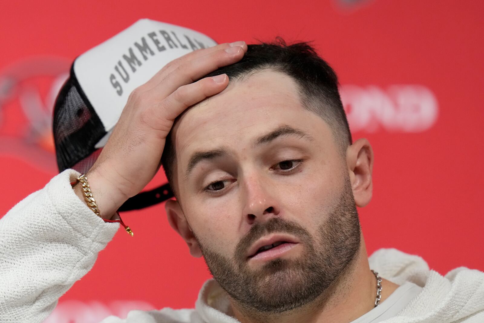 Tampa Bay Buccaneers quarterback Baker Mayfield reacts while speaking at a news conference after an NFL wild-card playoff football game against the Washington Commanders in Tampa, Fla., Sunday, Jan. 12, 2025. (AP Photo/Chris O'Meara)