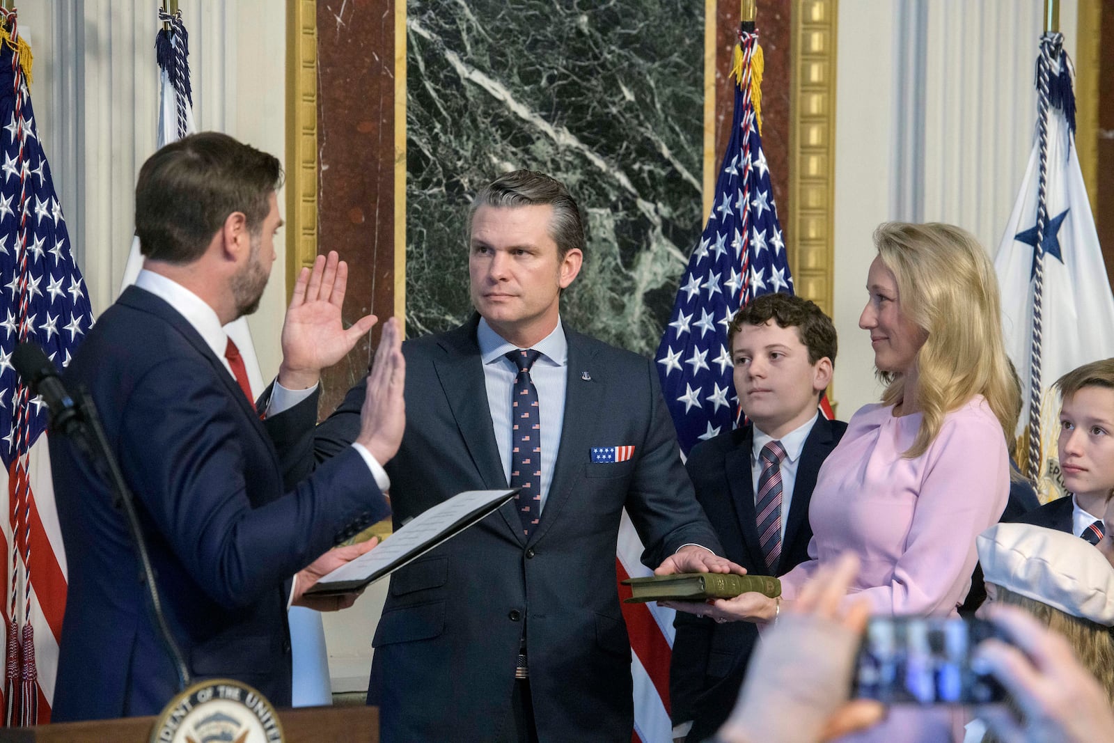 Vice President JD Vance, from left, swears in Pete Hegseth to be Secretary of Defense as his wife Jennifer Rauchet holds the Bible and Hegseth's children watch in the Indian Treaty Room of the Eisenhower Executive Office Building on the White House campus in Washington, Saturday, Jan. 25, 2025. (AP Photo/Rod Lamkey, Jr.)