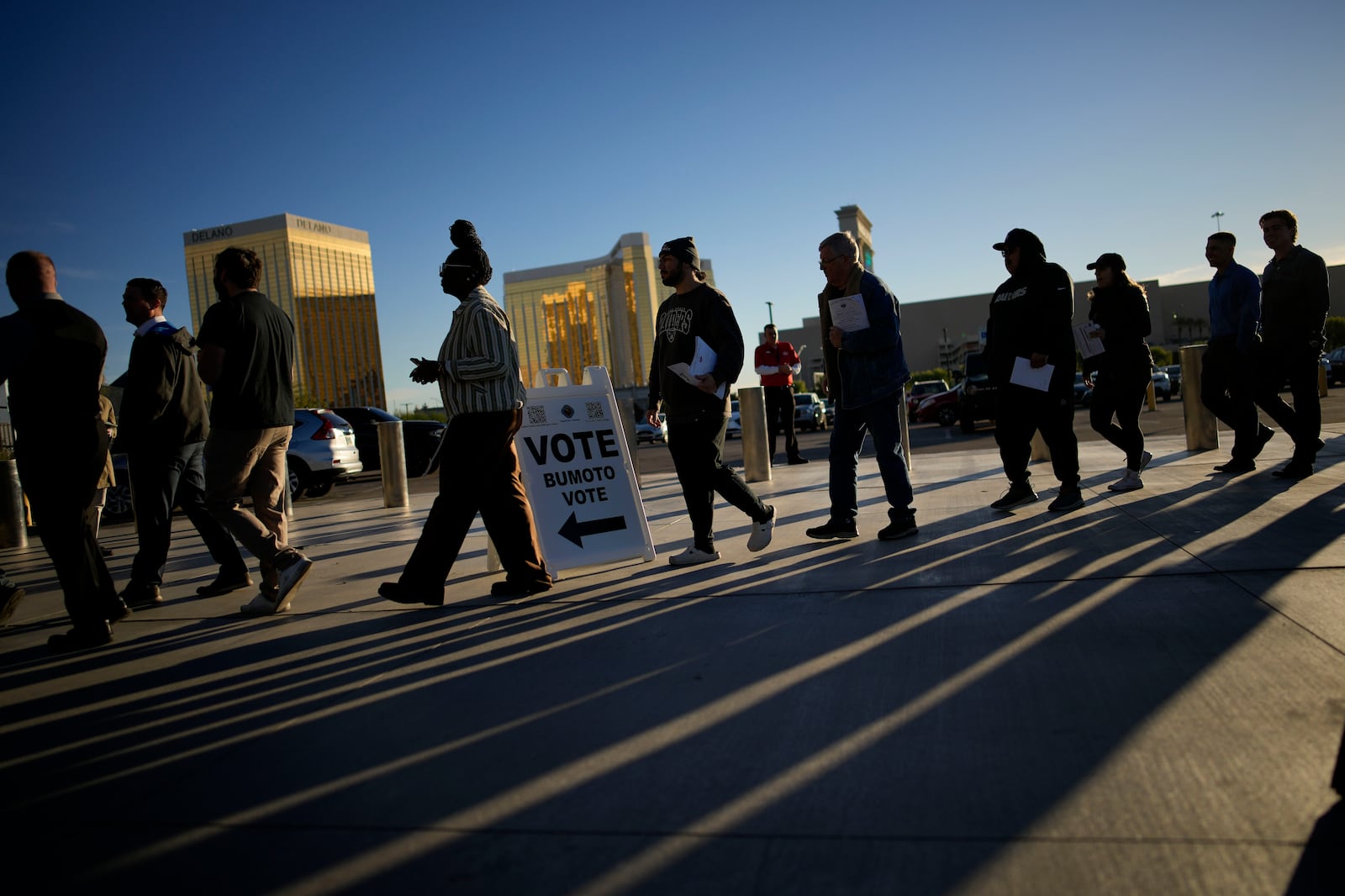 People line up to vote outside Allegiant Stadium, Tuesday, Nov. 5, 2024, in Las Vegas. (AP Photo/John Locher)